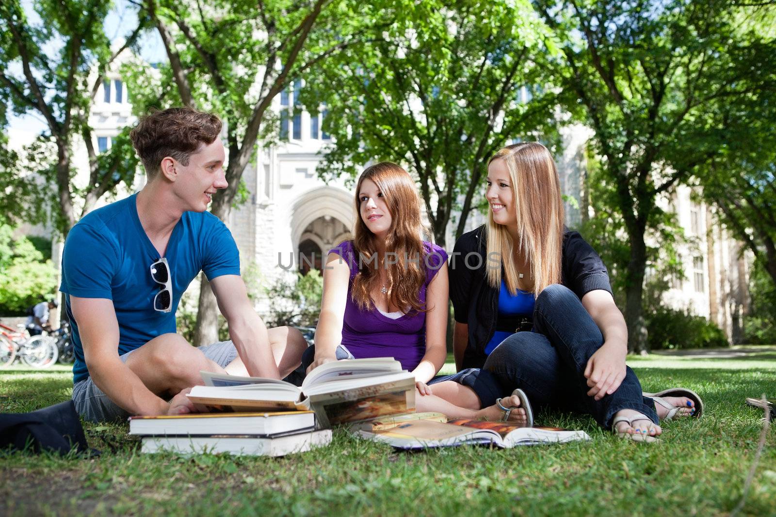 Students on campus ground by leaf