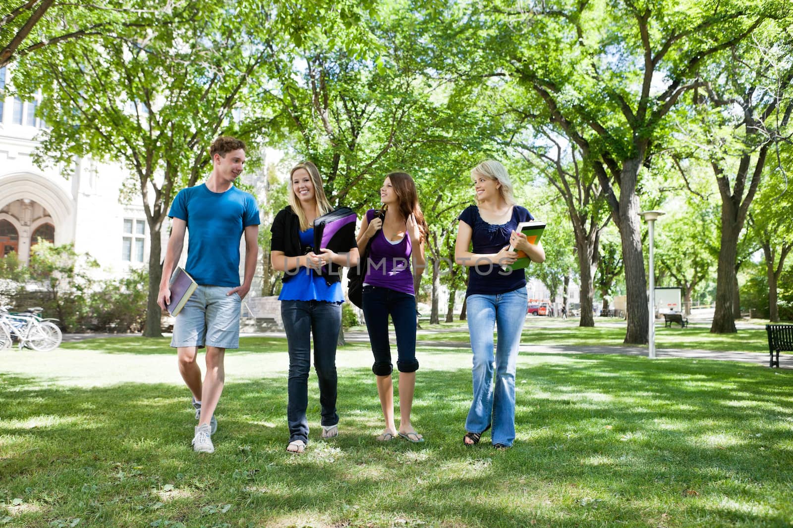 Group of college students walking in campus ground