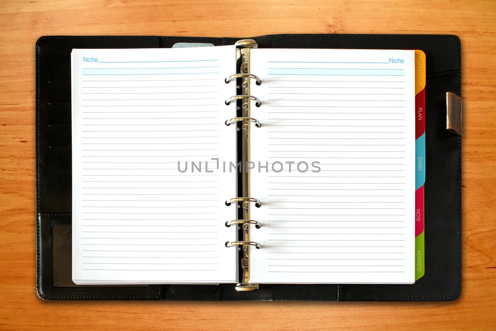 leather open notebook on old wooden background