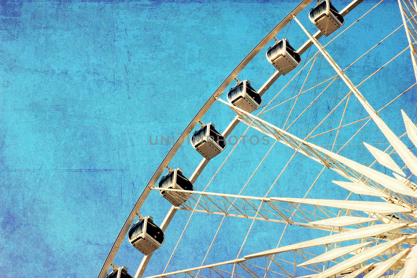 Close up of ferris wheel with blue sky, photo in old image style