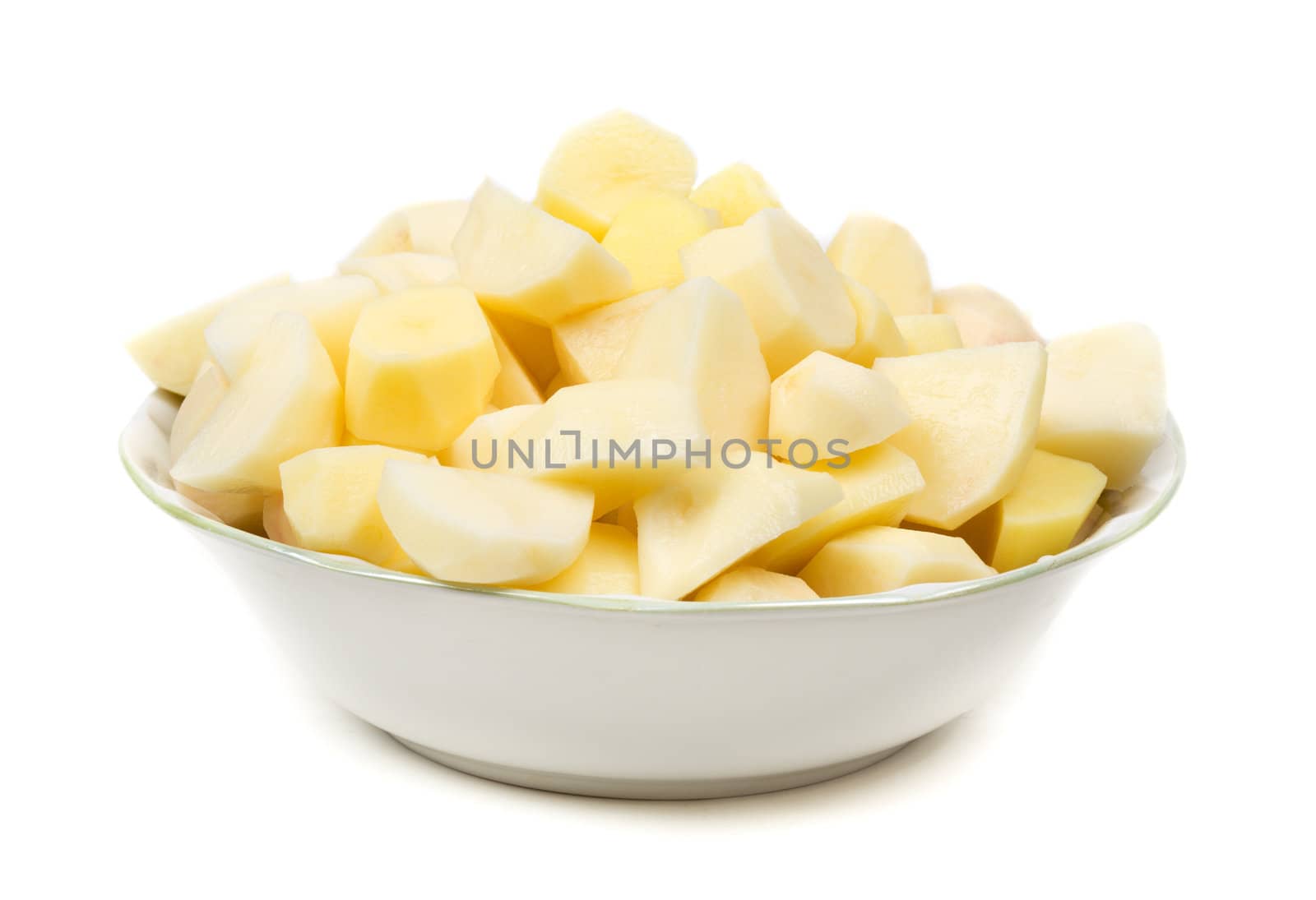 plate with peeled potatoes cut into pieces. Isolate on white