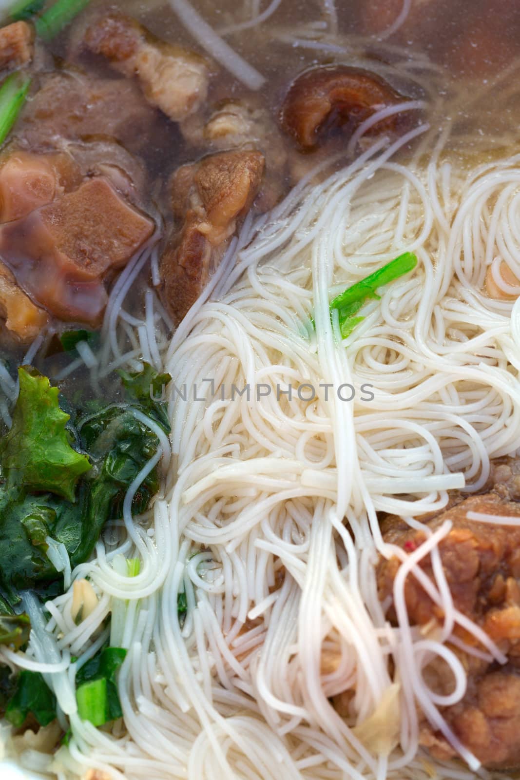 Thai noodle soup and pork meat closeup