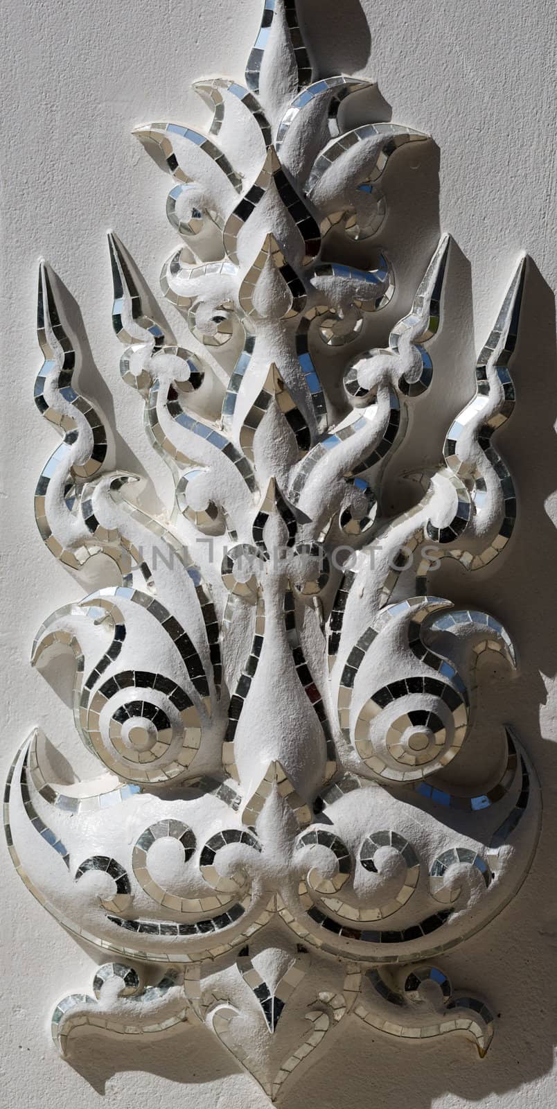 Asian sculpture of the deity face close-up of the White Temple in Chiang Mai, Thailand