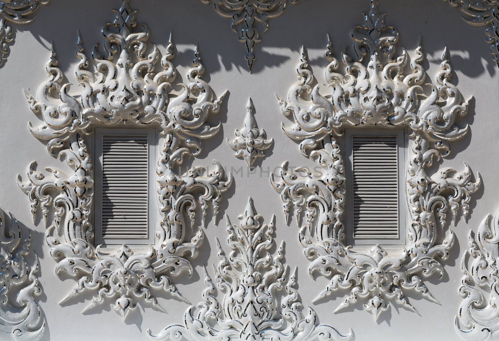windows in the building of the White Temple in Chiang Mai, Thailand