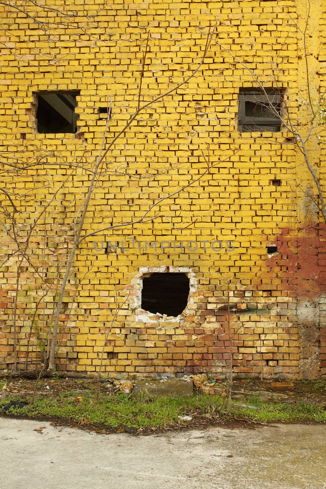 Brick wall  with windows that looks like a face