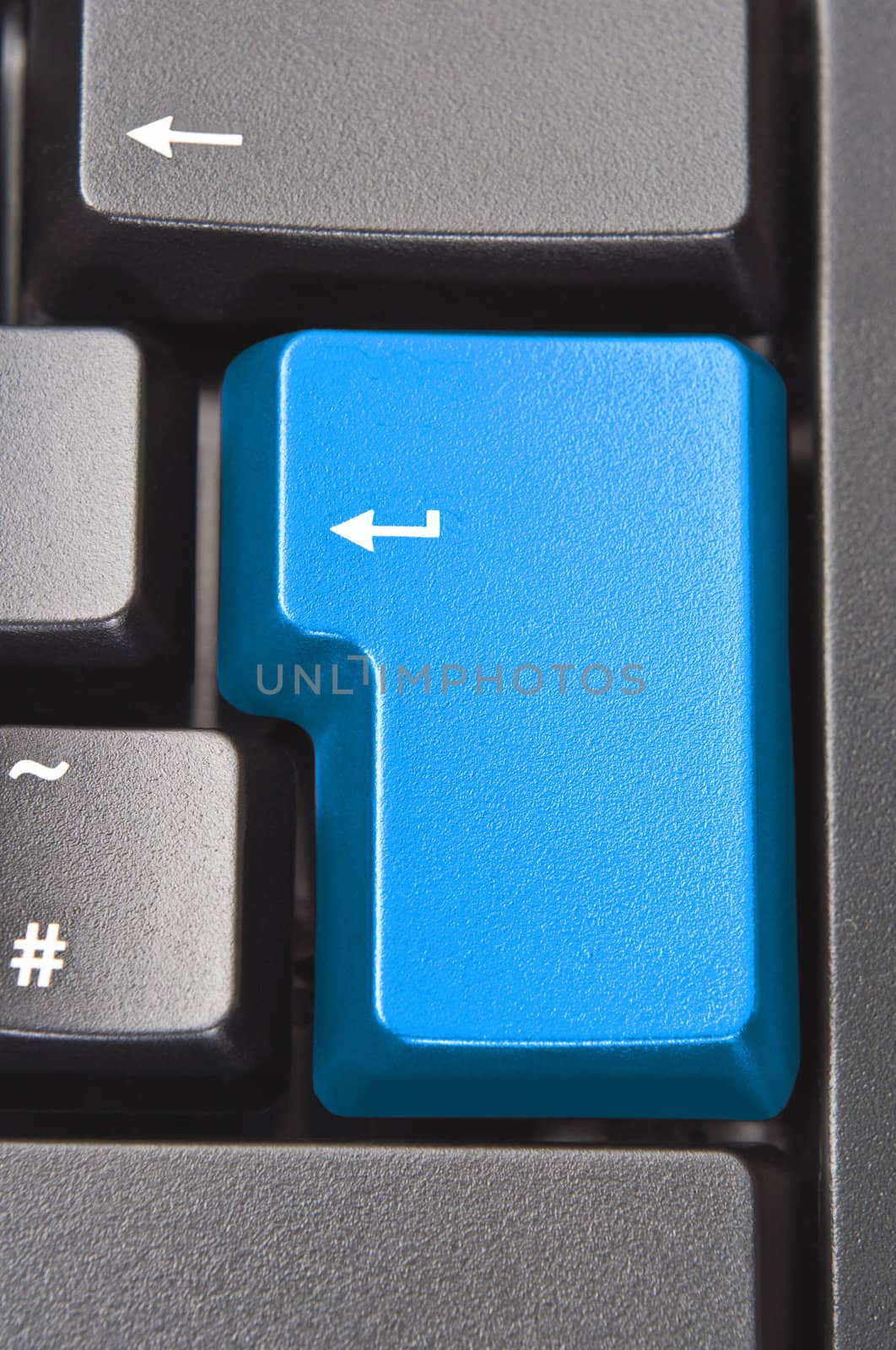 Close up (macro) shot of the 'Enter' aka 'Return' key on a black computer keyboard.  Coloured blue with original word removed.