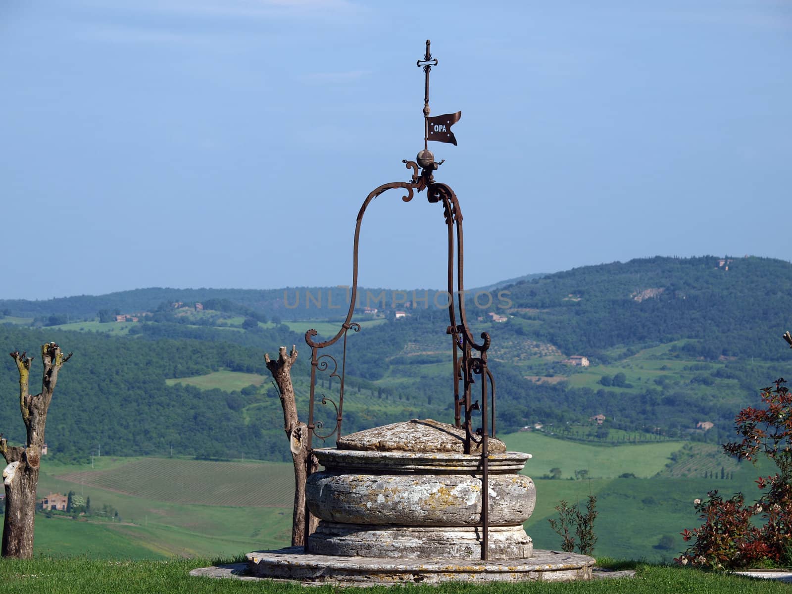 old well on the background of the Tuscan landscape