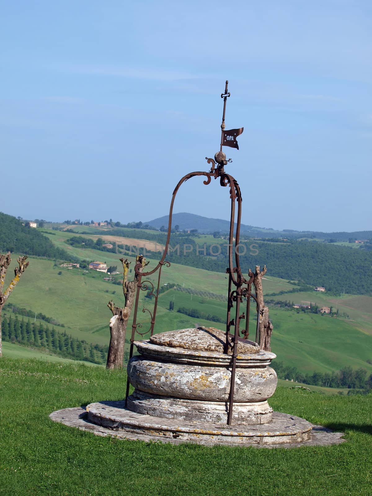 old well on the background of the Tuscan landscape