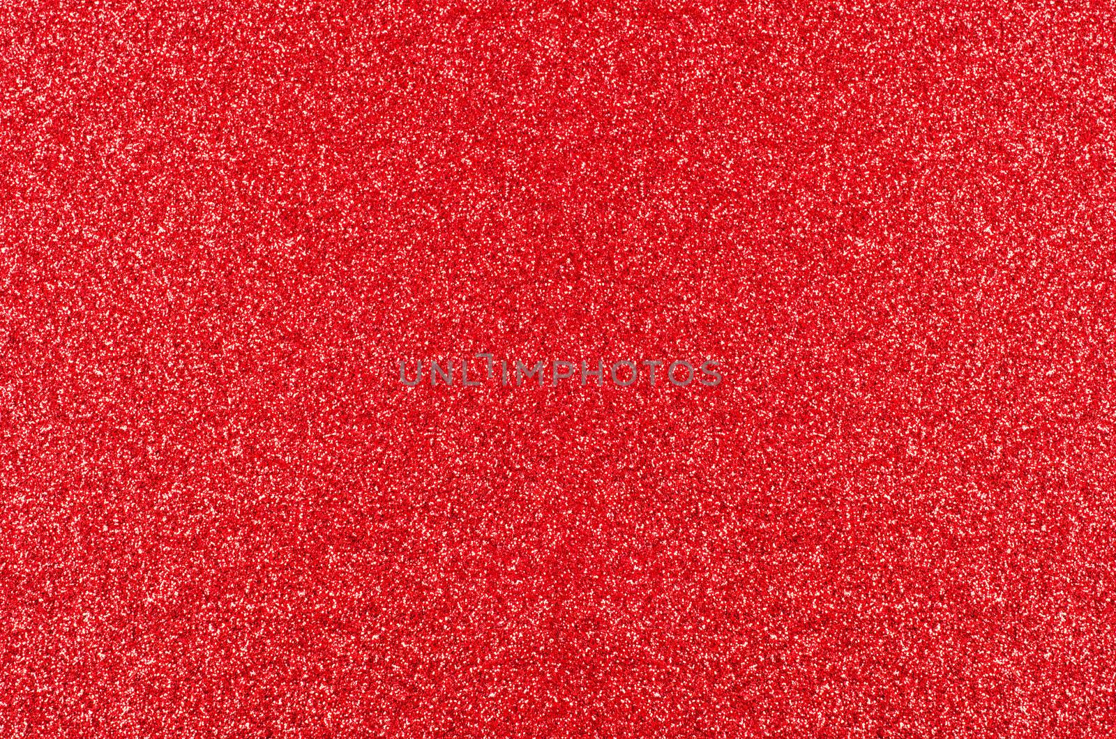 A Christmas texture background of red glitter, evenly spread from edge to edge of frame.