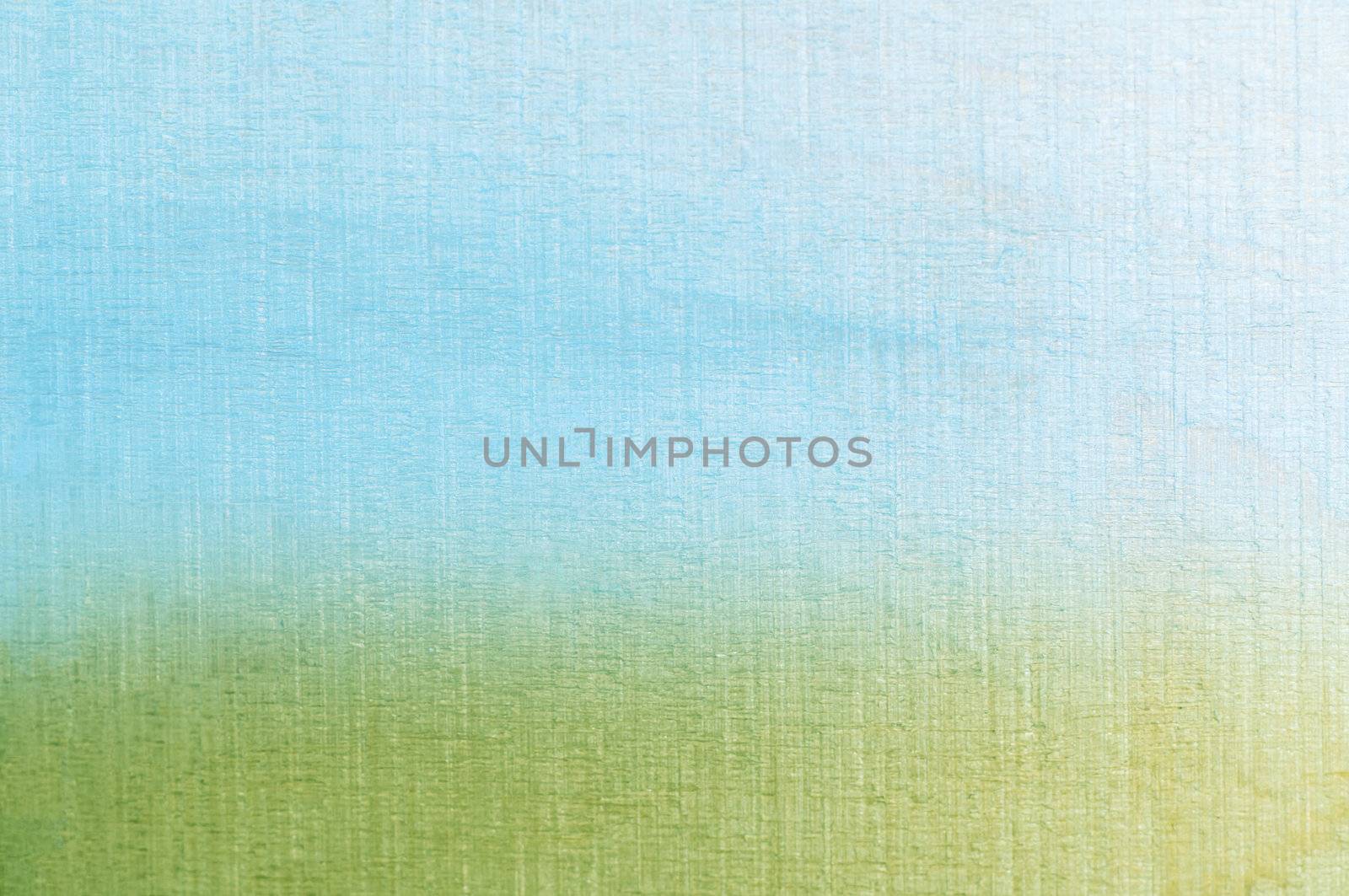 Woodgrain photograph tinted with blue and green colours, softly merging together at horizon to create an abstract painterly grass and sky textured background.