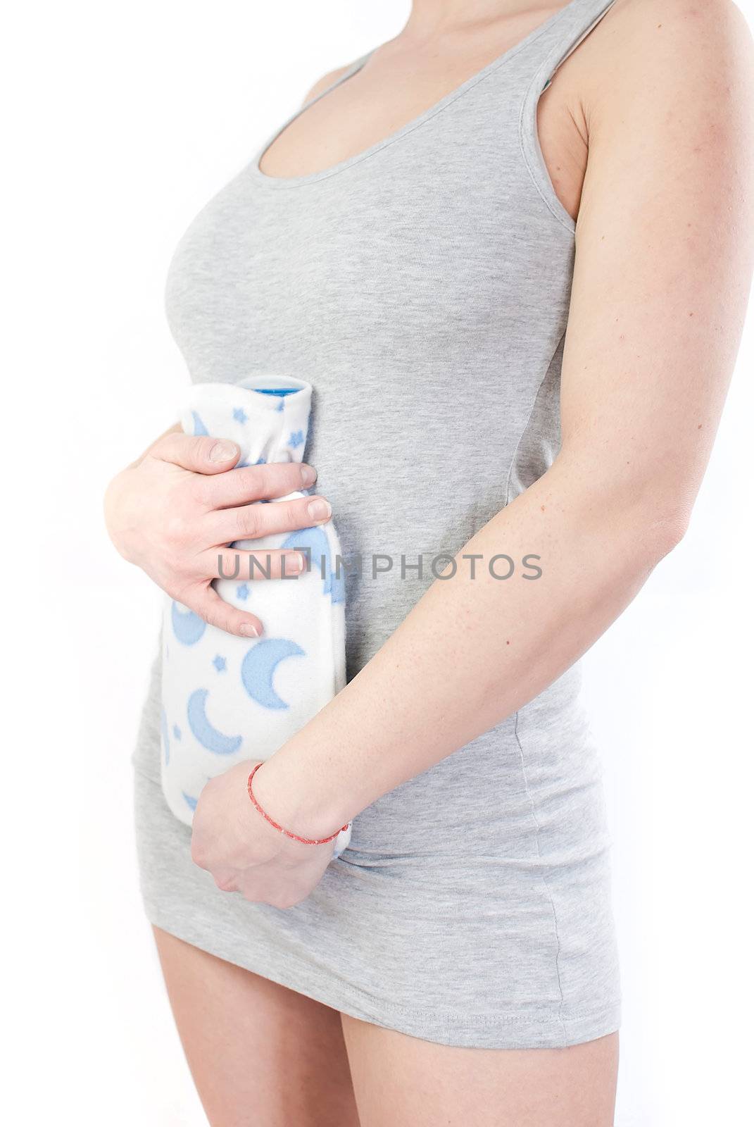 young woman with stomach pain holding hot water bottle