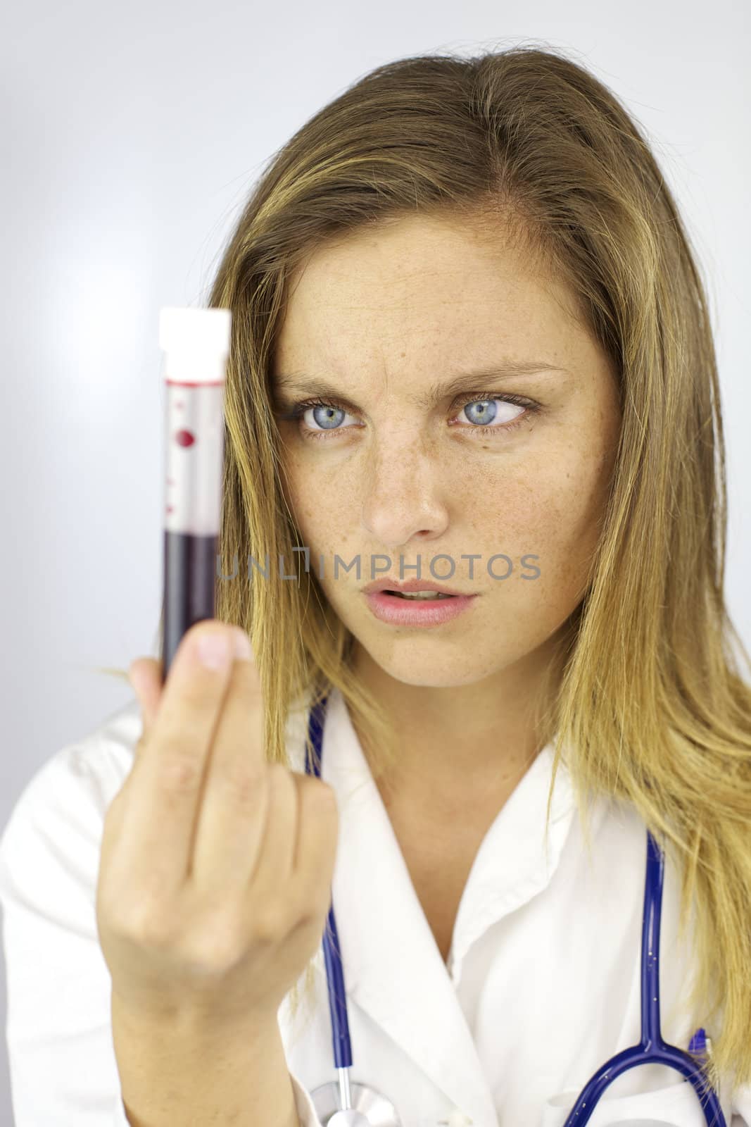 Female doctor observing blood sample