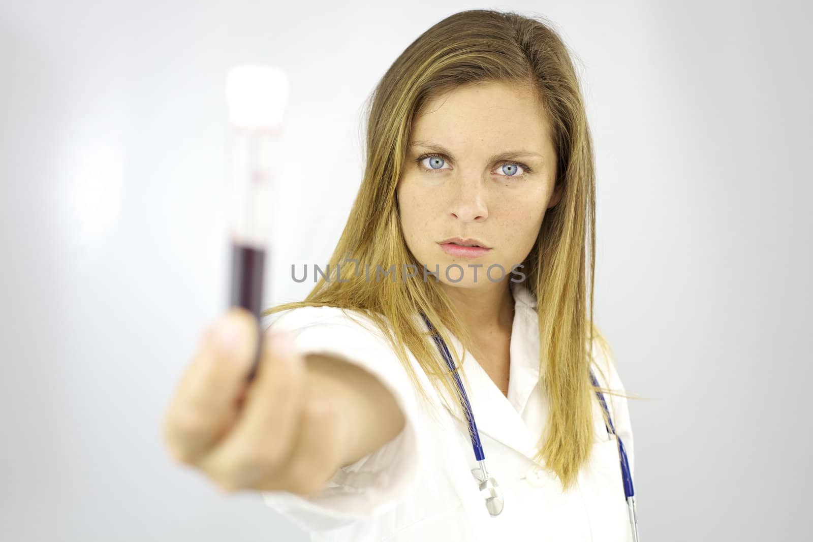 Beautiful woman doctor showing blood sample for study and research