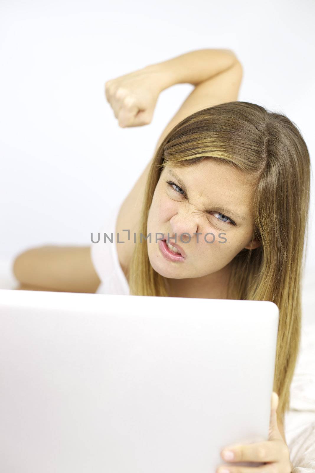 Very angry woman wanting to punch computer and destroy technology