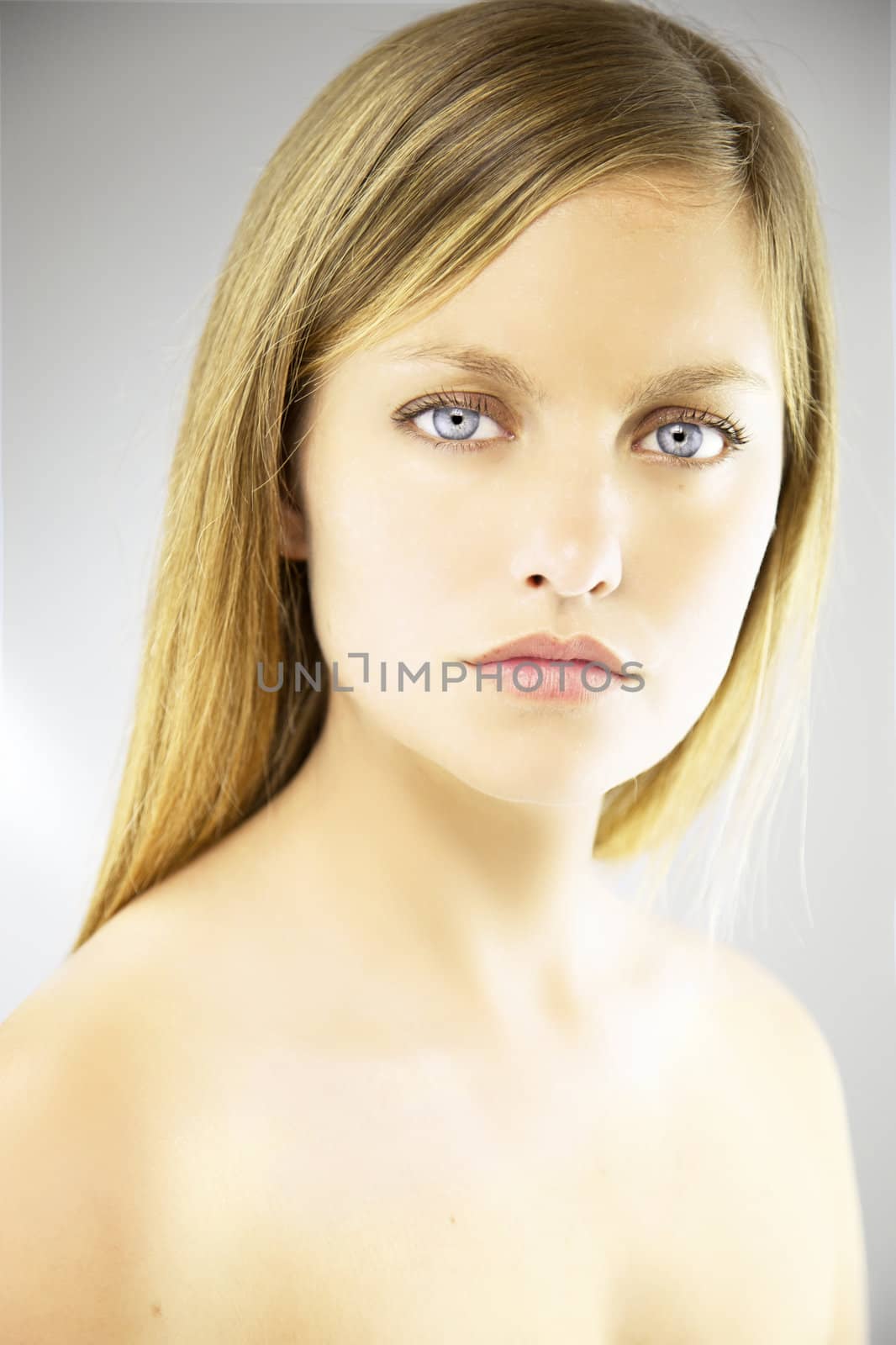 Portrait of beautiful blonde woman with blue eyes by fmarsicano