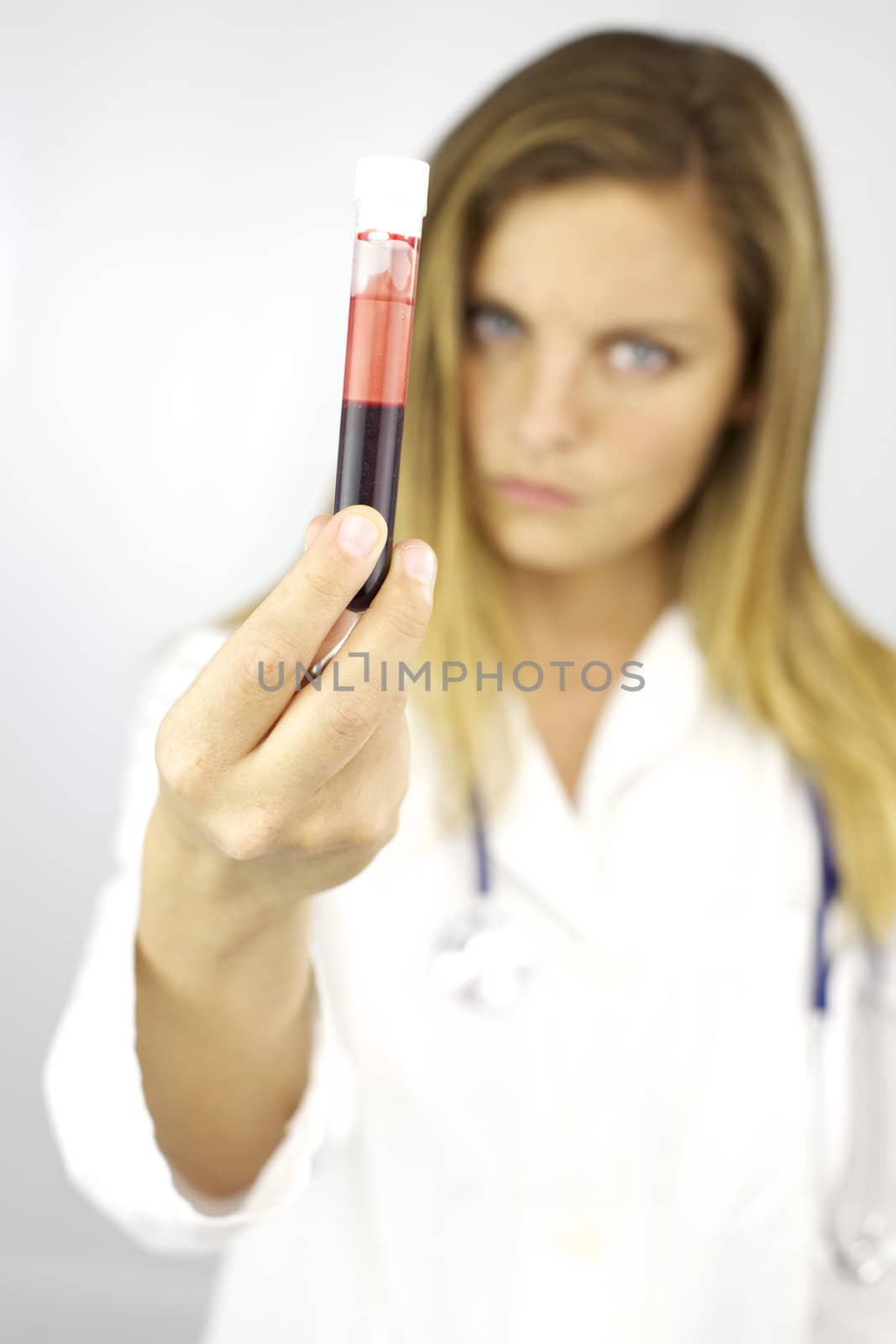 Good looking blond female doctor ready to do test on blood sample