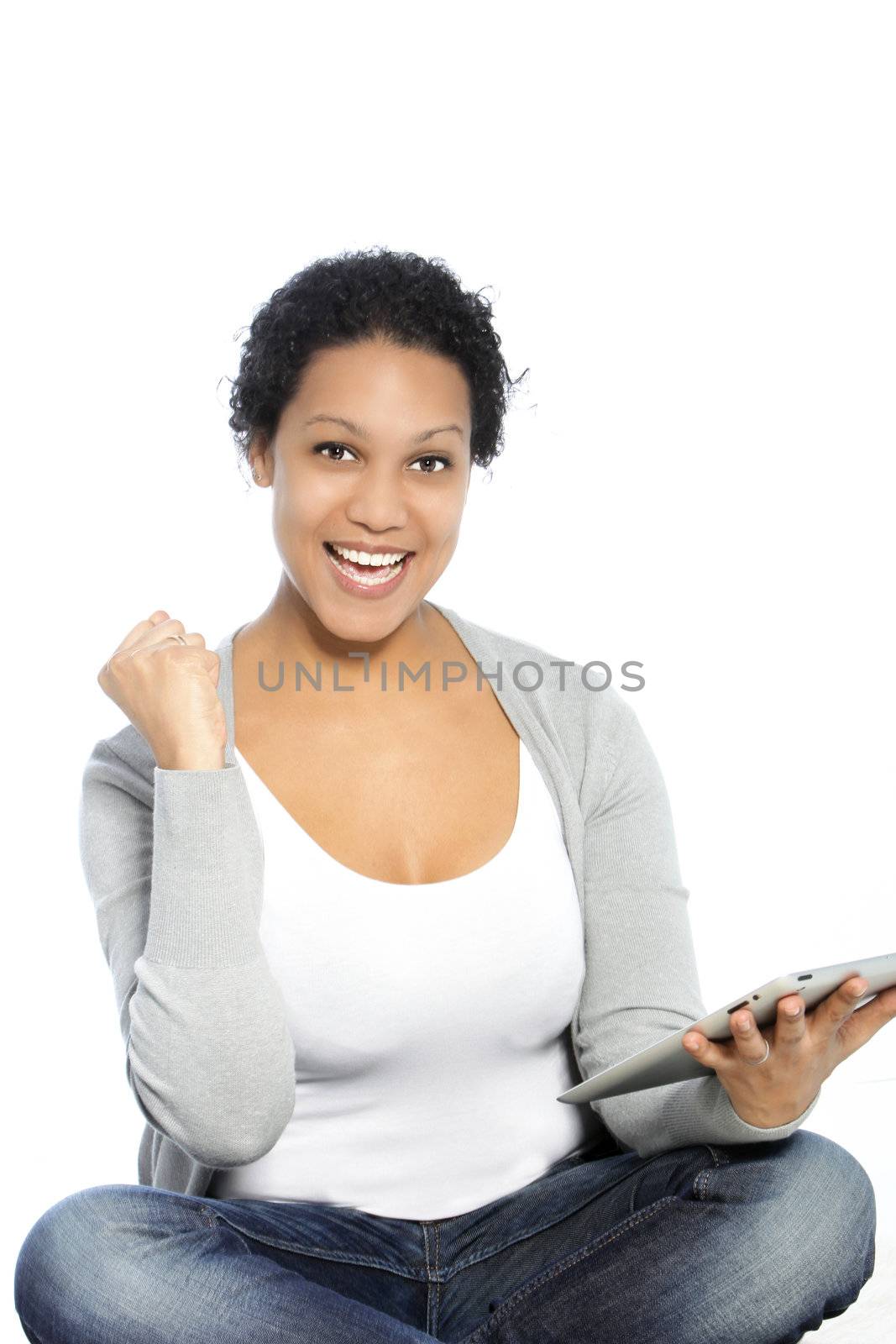 Happy woman raising her fist and holding tablet-pc on her other hand
