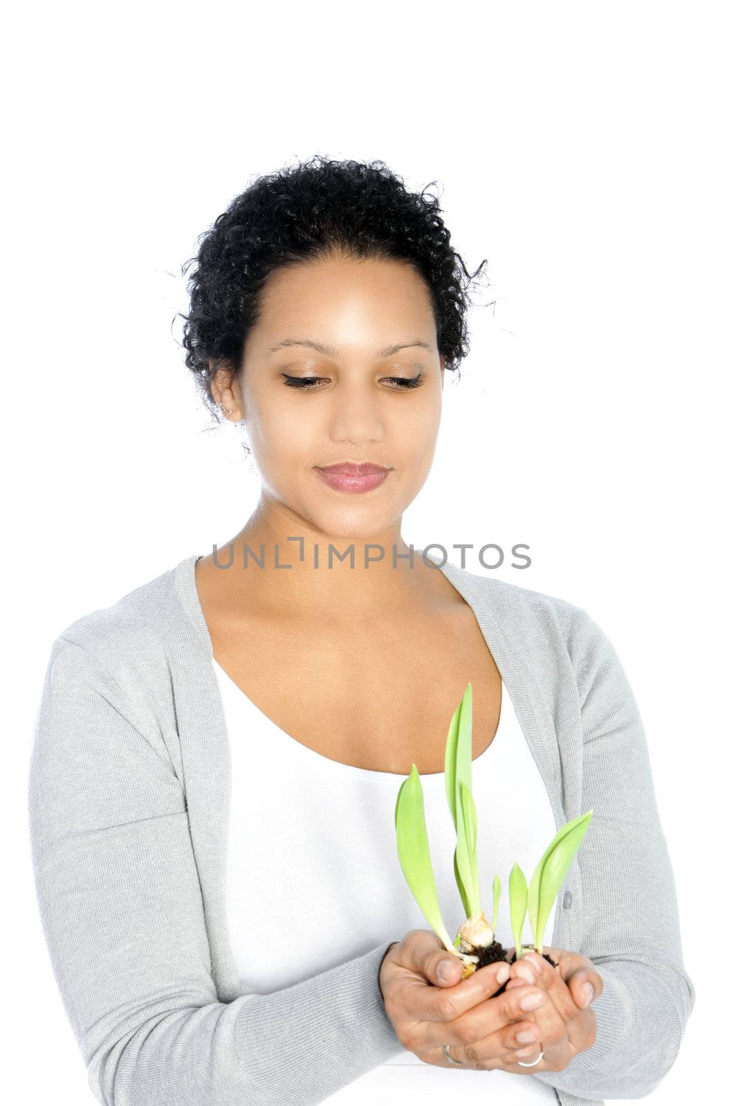 Afro-American young woman holding a plant, on white background
