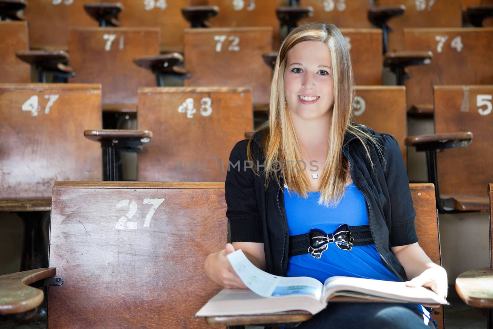 Girl studying at university hall by leaf