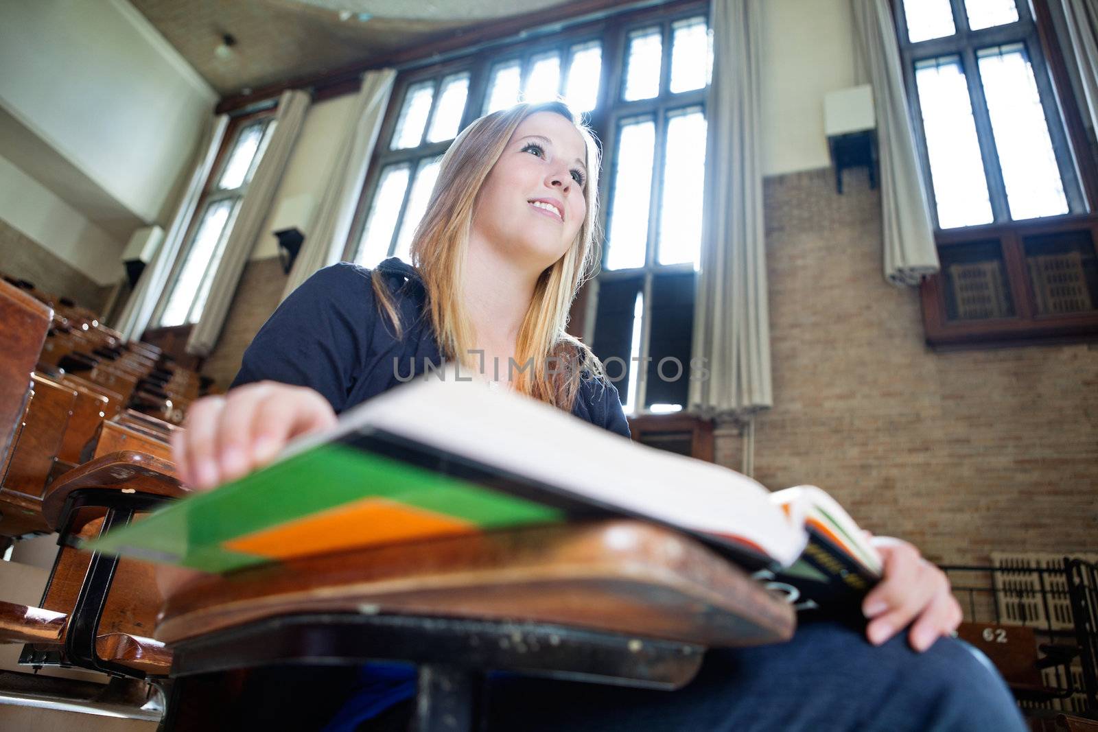 Girl paying attention in lecture by leaf