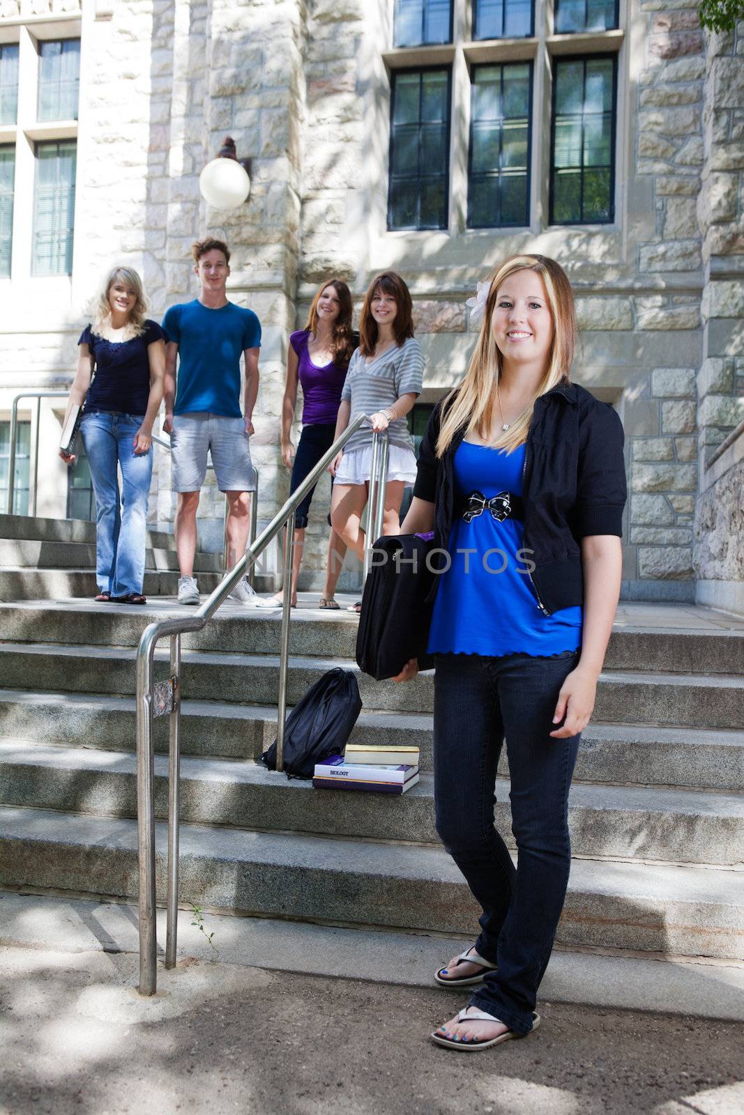 College students on the stairs of college building