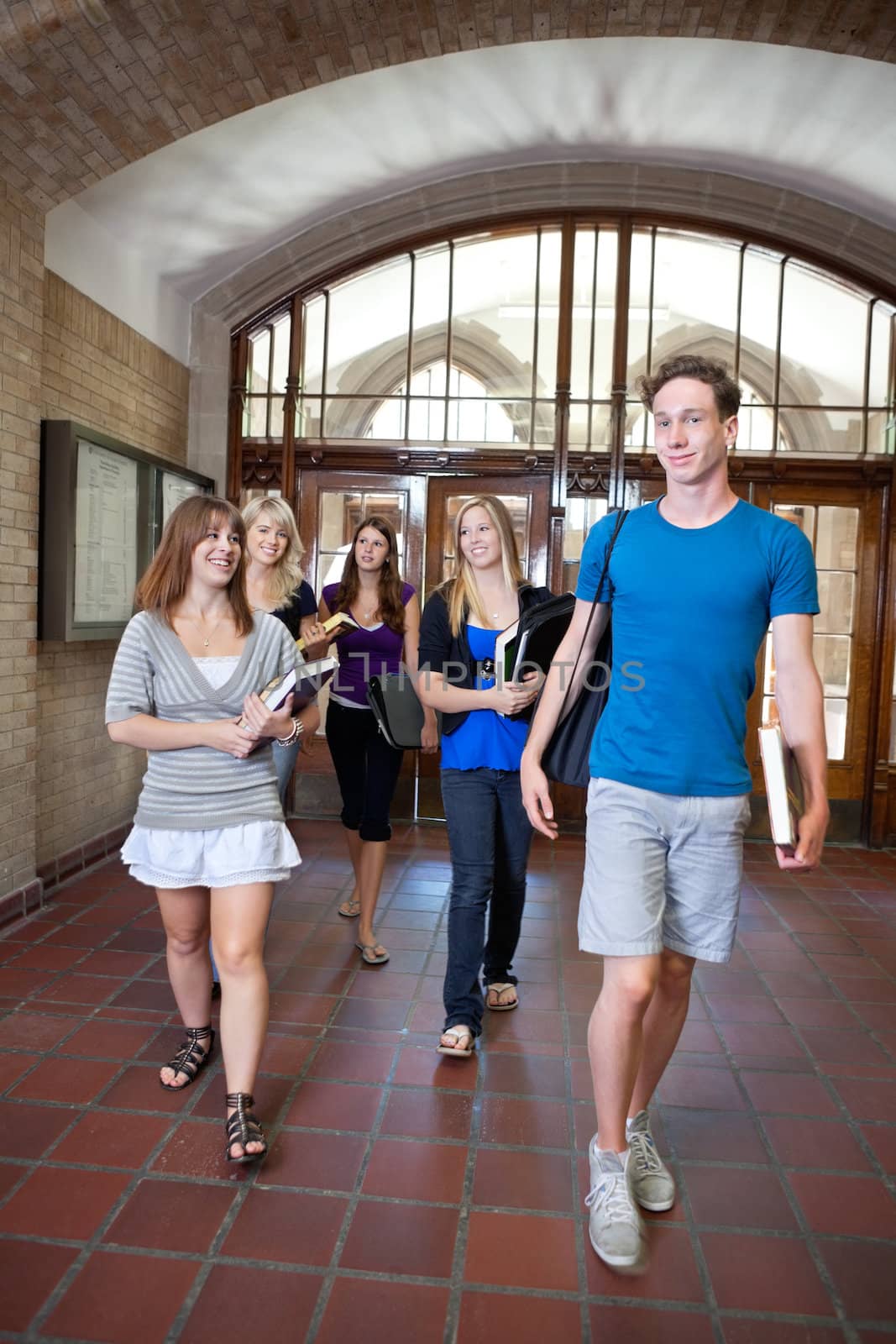 Group of college students walking through hall