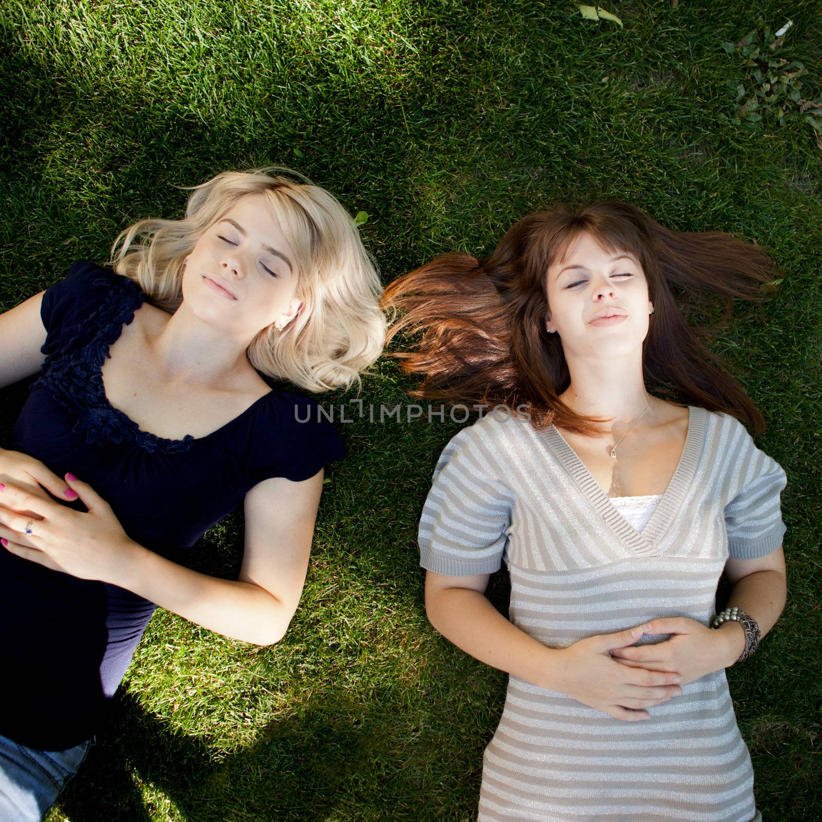 Two young women relaxing on grass