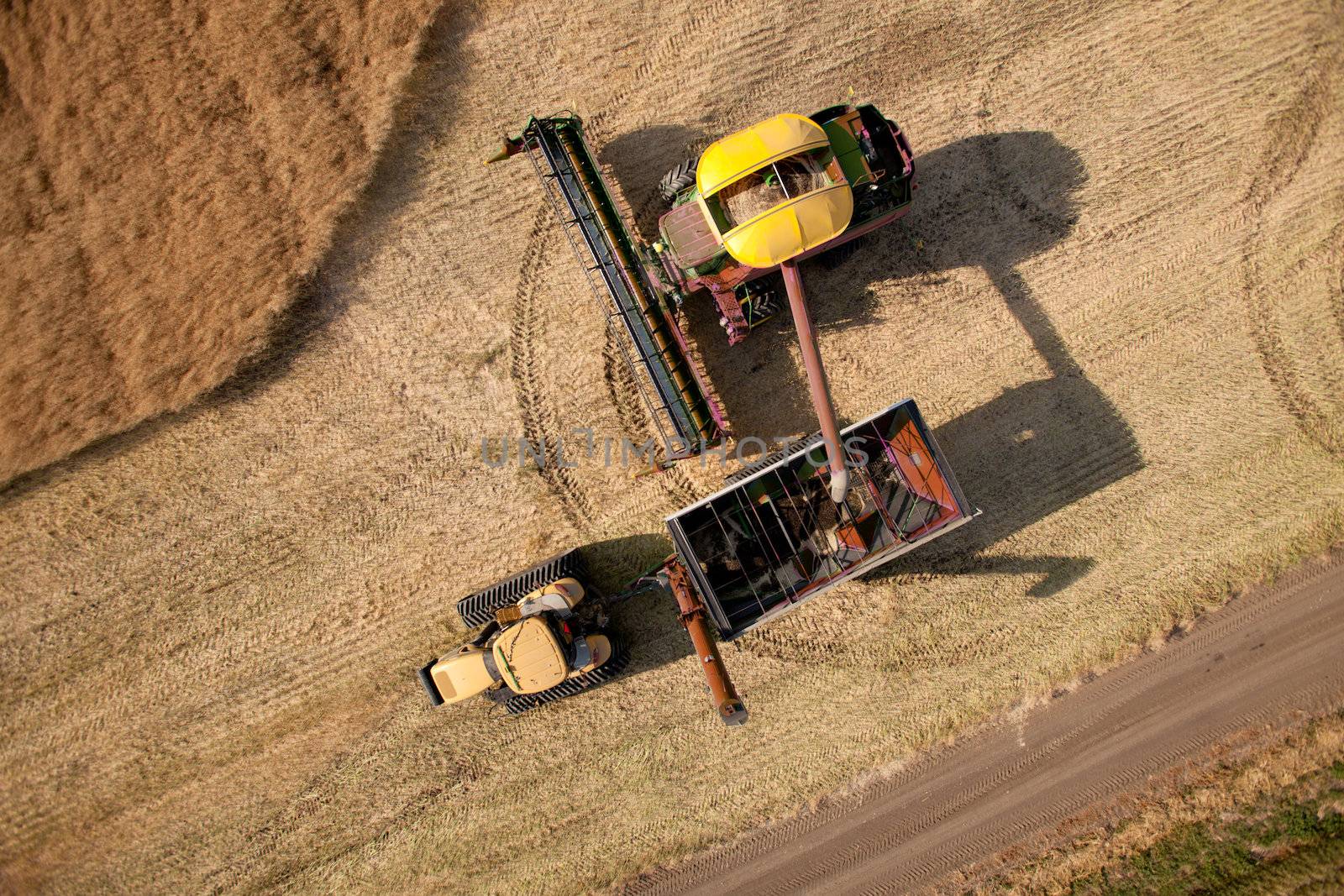 Top down view of a harvester unloading crop into a grain cart