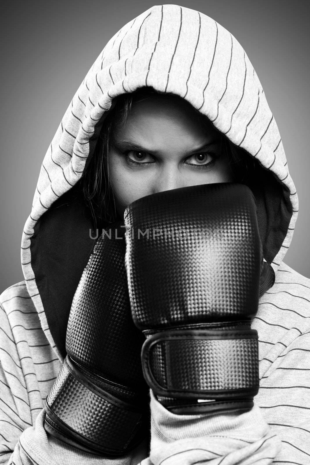 Black and white portrait of a woman with boxing gloves