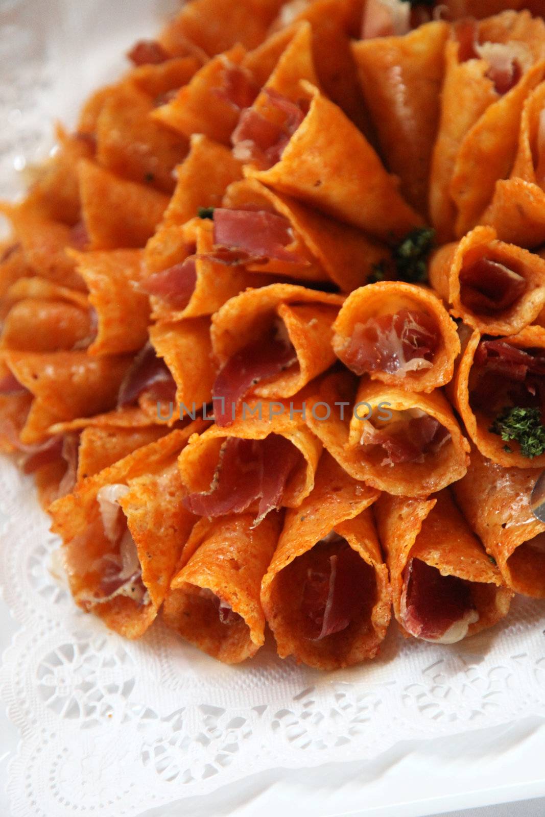 Close up of brandy snap cones on a white plate.