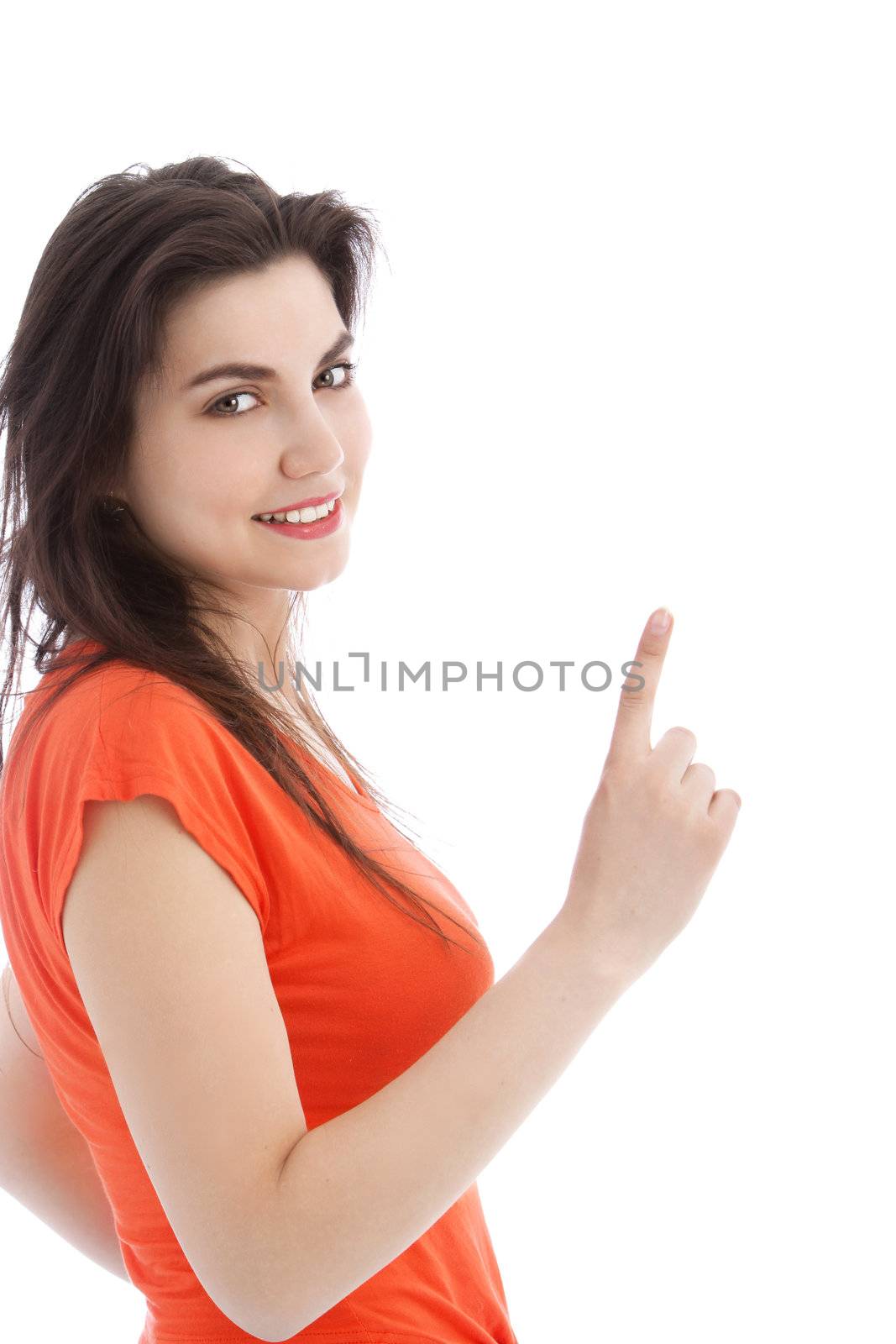 Long haired brunette young woman pointing up, on white background