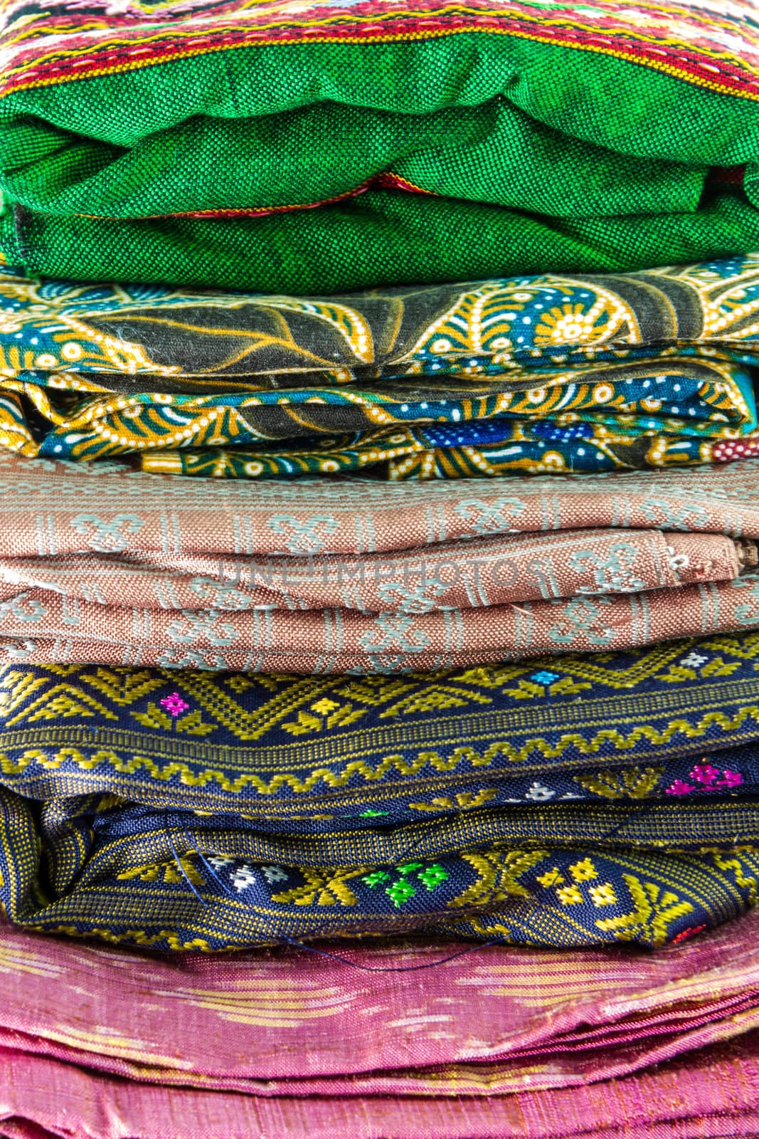 Stack of colorful thai silk by bunwit