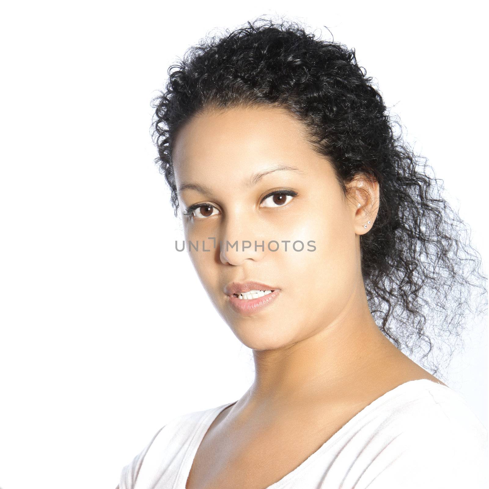 Closeup head portrait of a serious beautiful young African American woman looking at the camera isolated on white