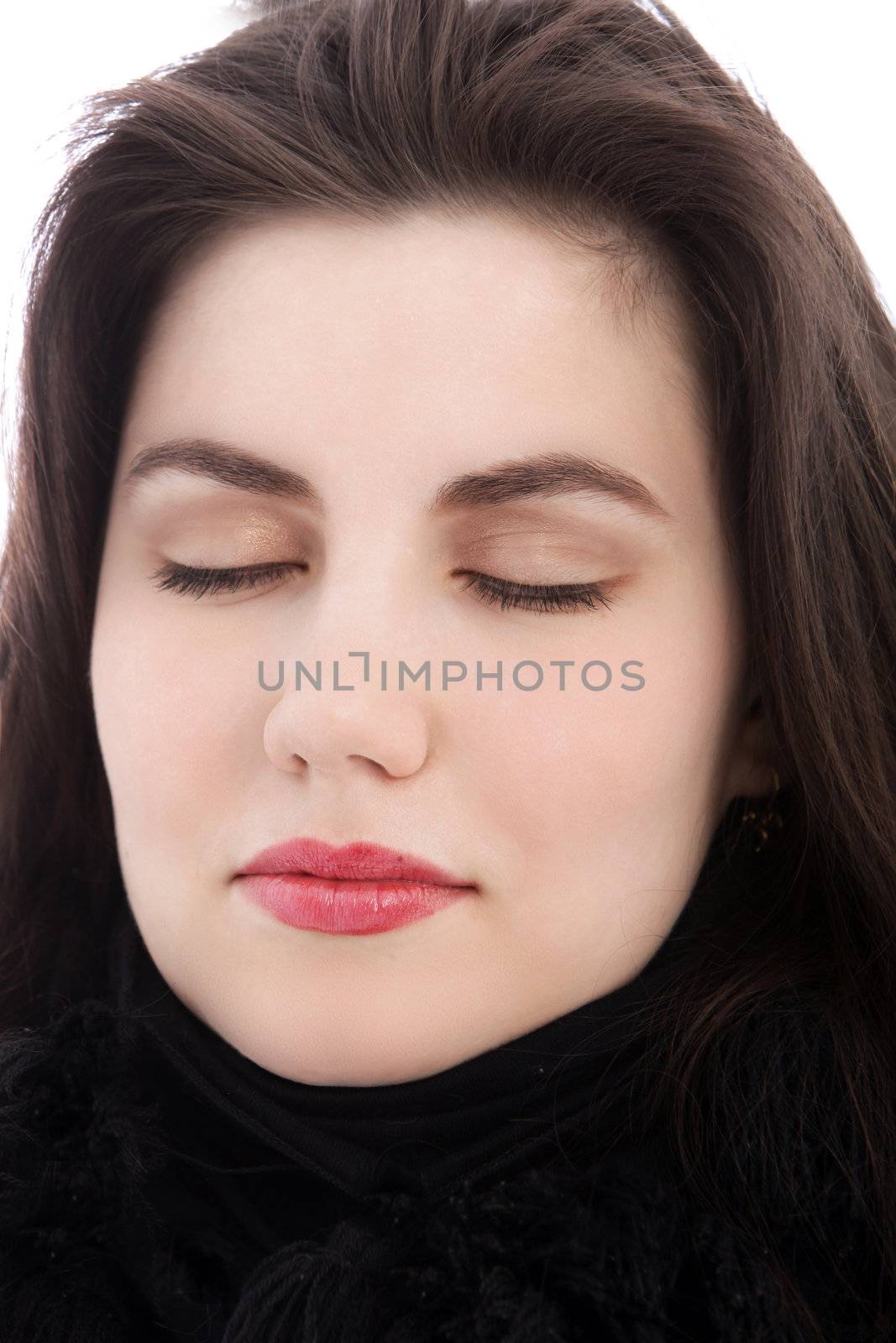 Relaxed young brunette woman meditating with eyes closed, close up