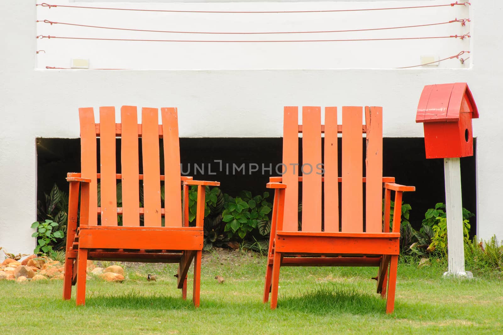 Red classic chairs in garden.