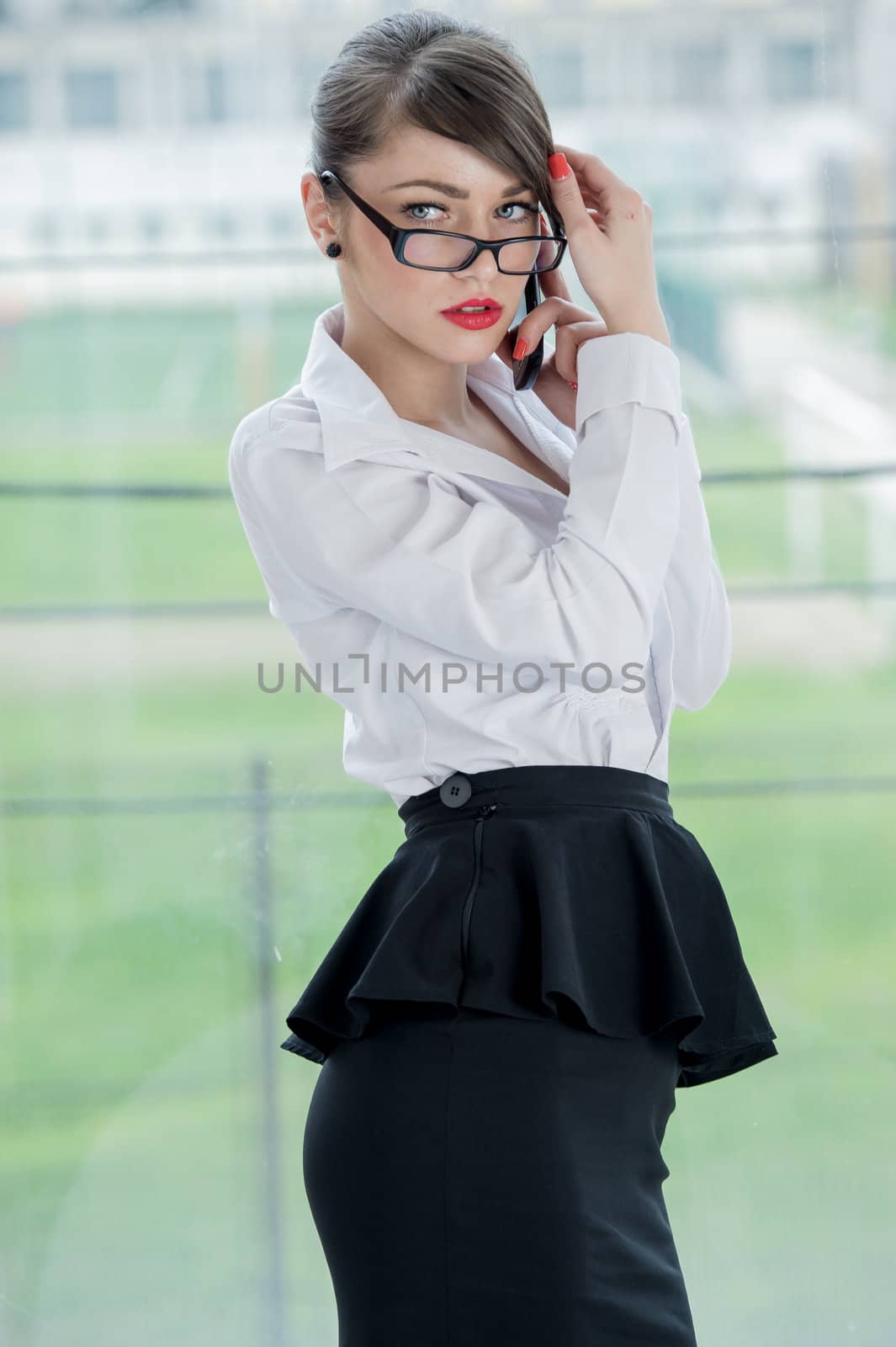 beautiful businesswoman with phone and laptop