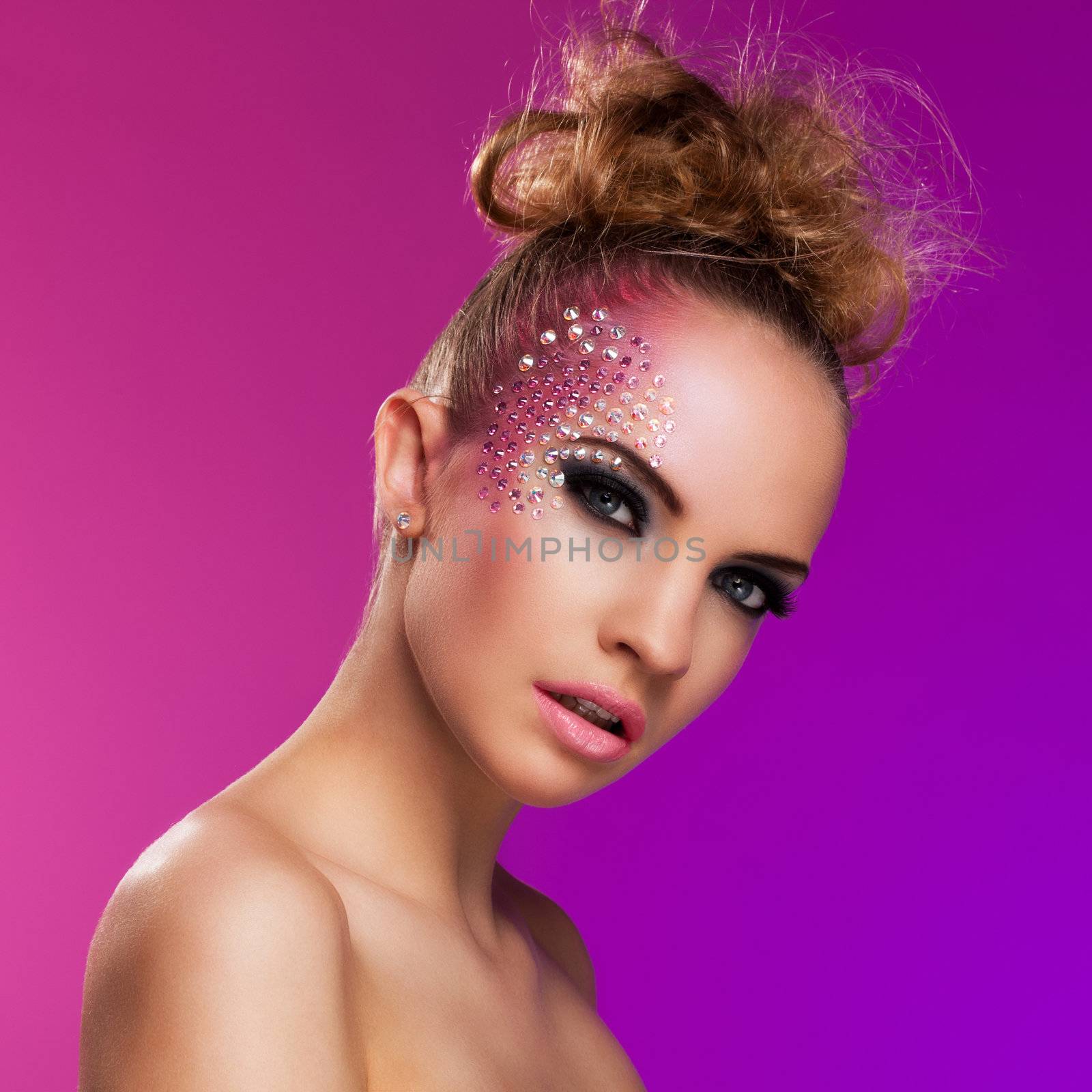 Beautiful woman with fantasy makeup on a violet background