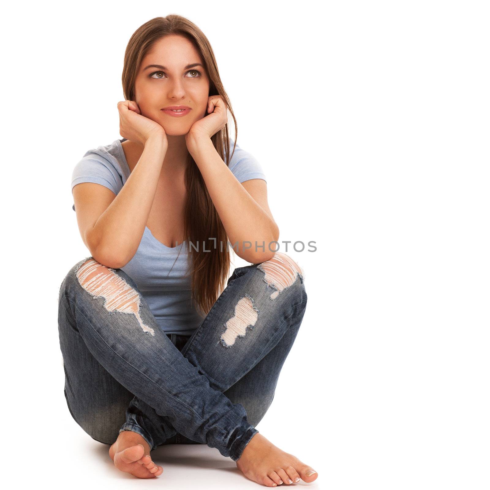 Young happy caucasian woman sitting isolated over white background