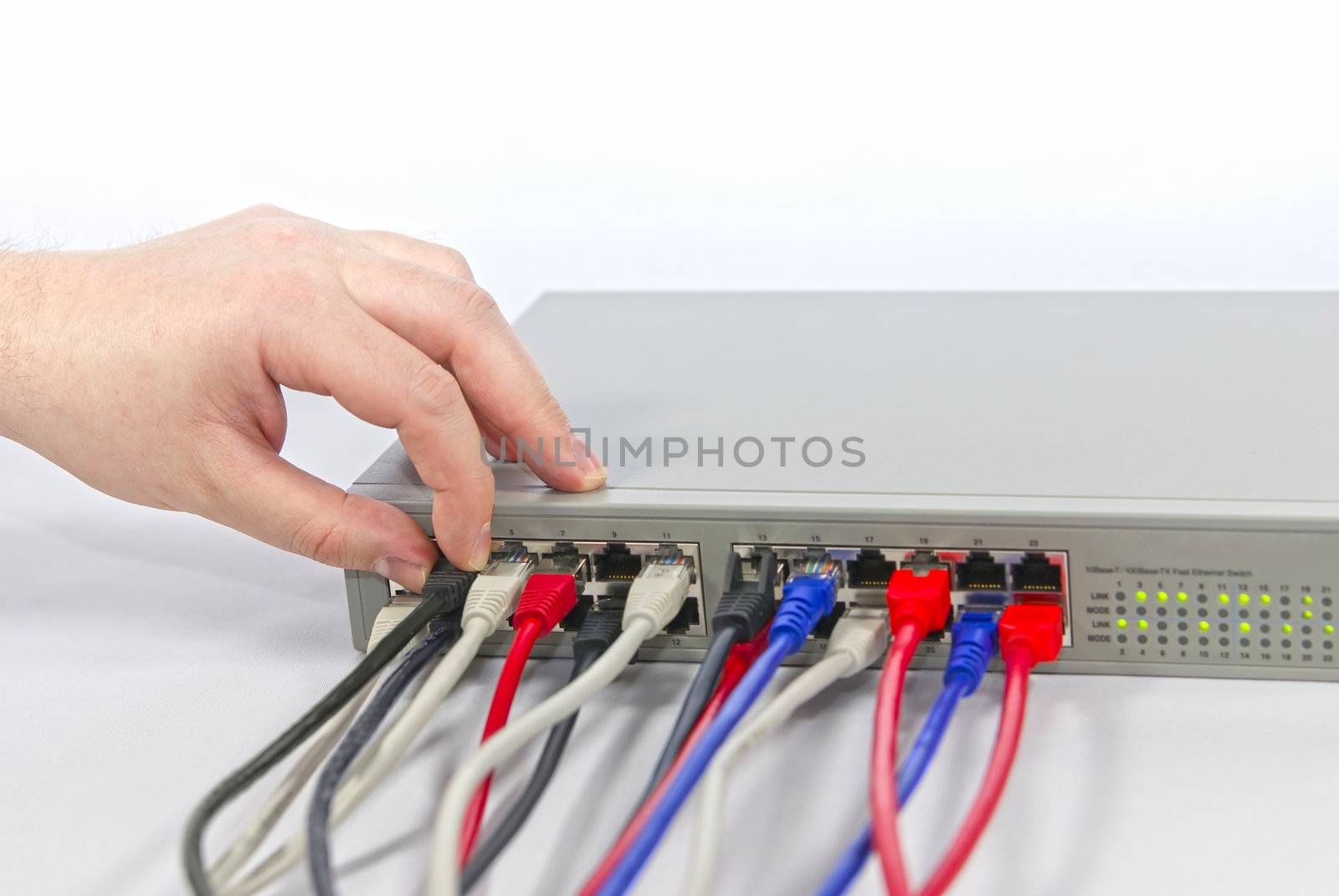 Network switsch and man's hand with cabels