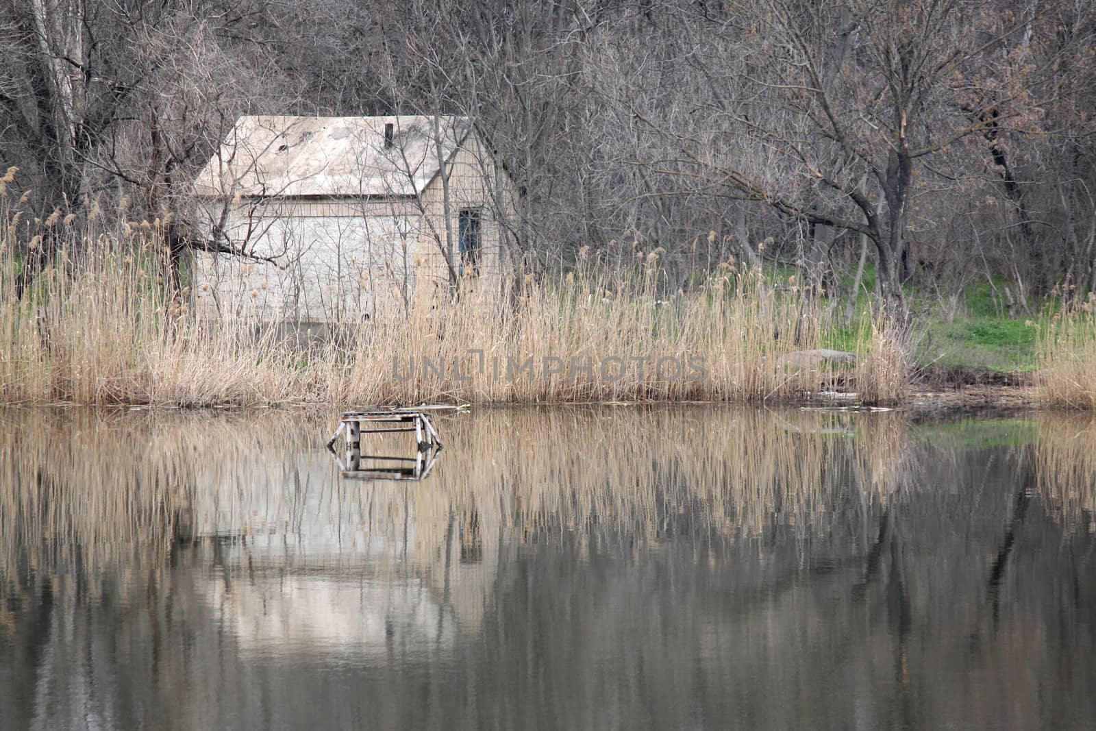 riverside landscape with uninhabited house