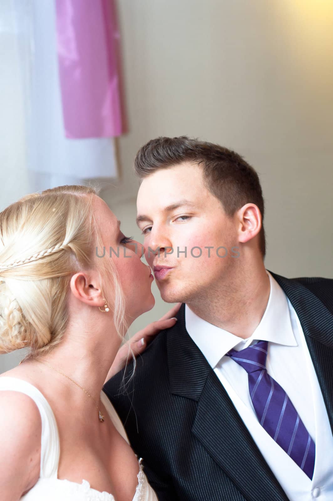 Handsome groom kissing her bride by svedoliver