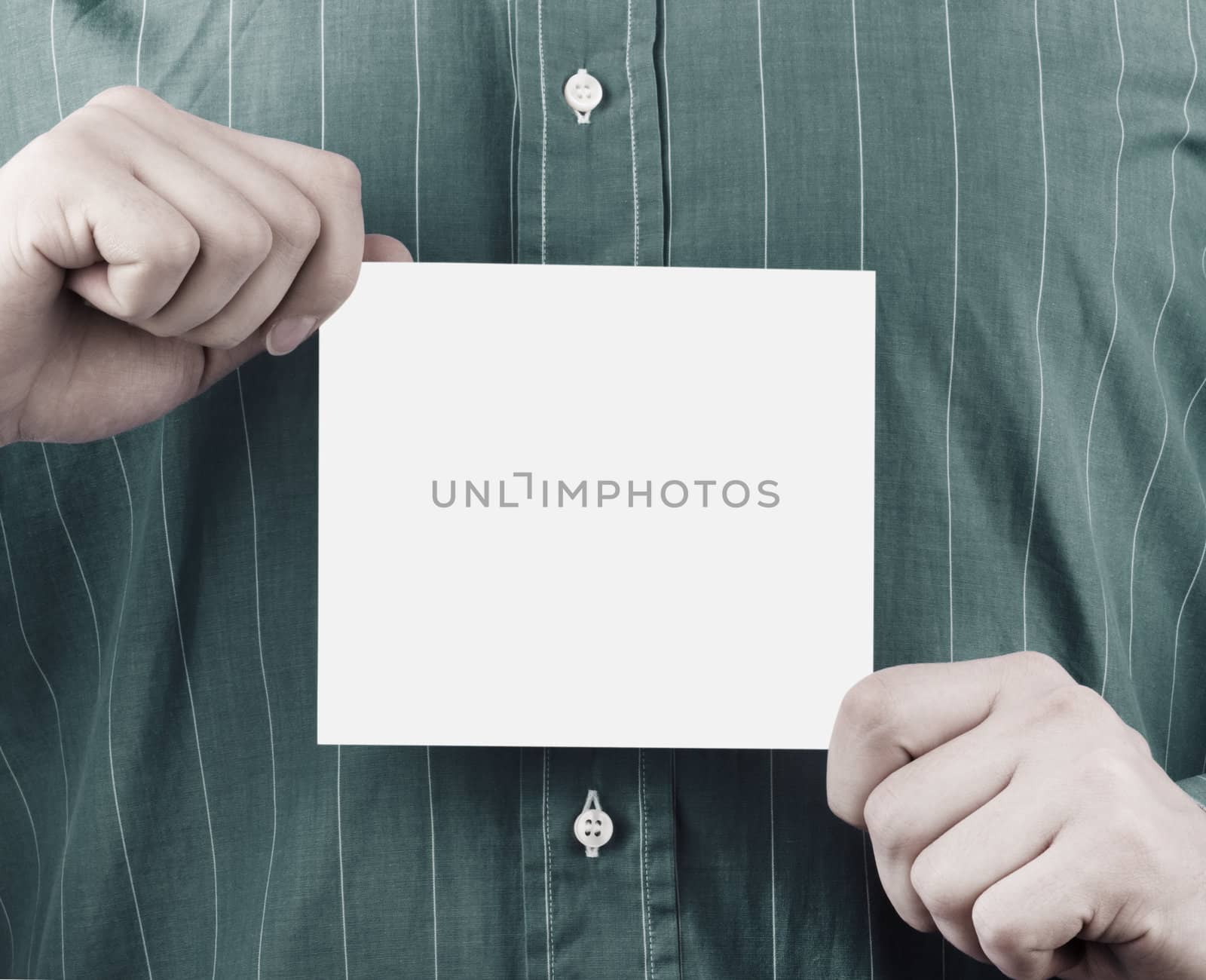 Closeup of businessman's hand holding up card