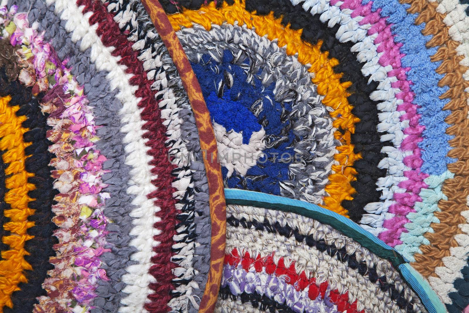 Handmade rugs crocheted of colorful fabric ribbons