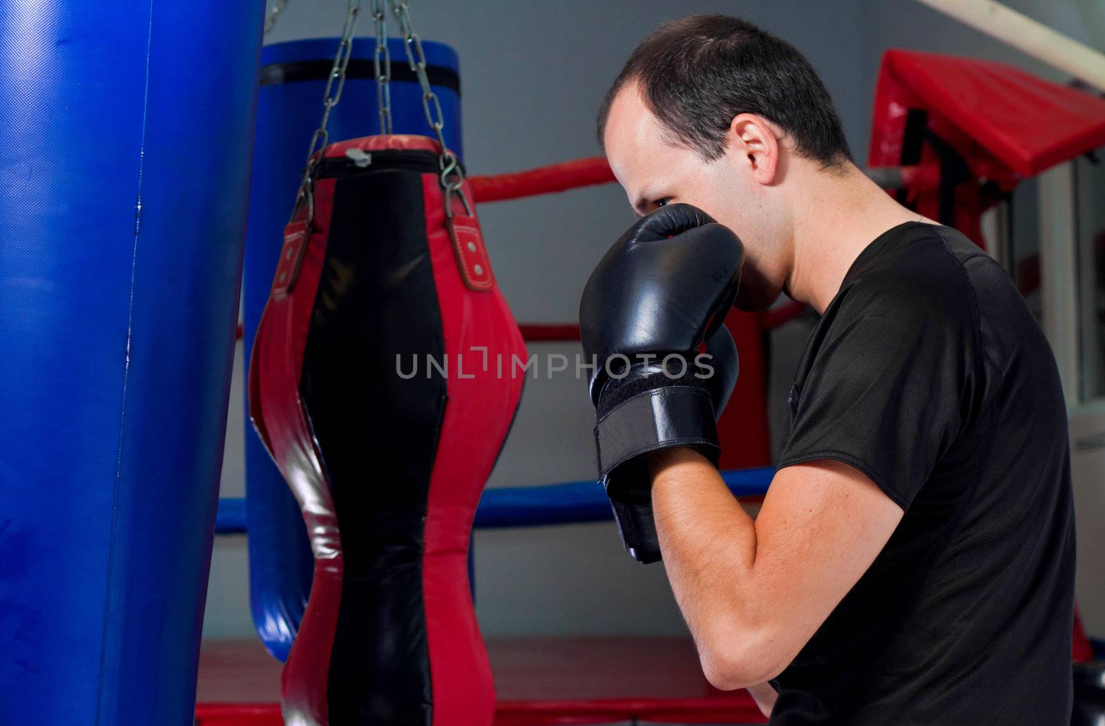 Boxer training with a sand bag