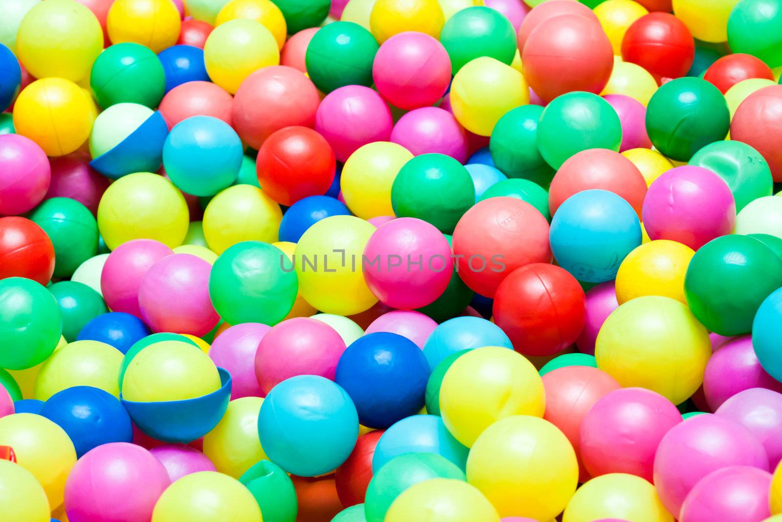 Colorful balls in a playground for kids by Lamarinx