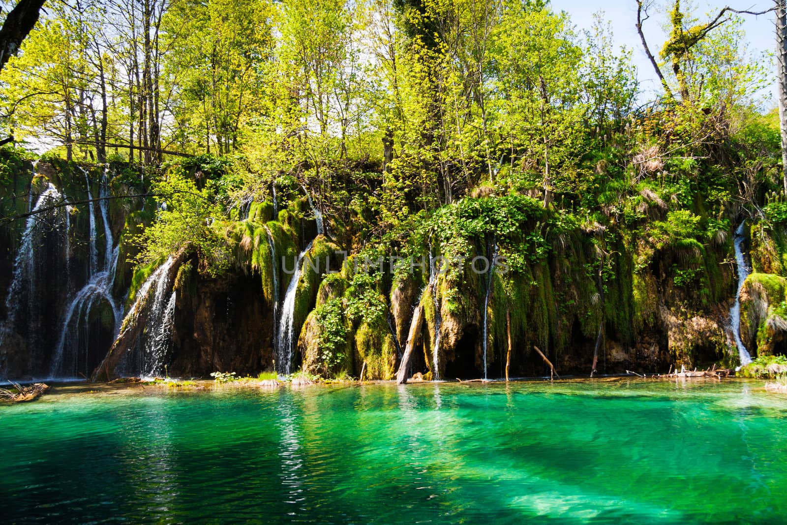 Green lake with waterfalls, shot at Plitvice lakes national park, Croatia.