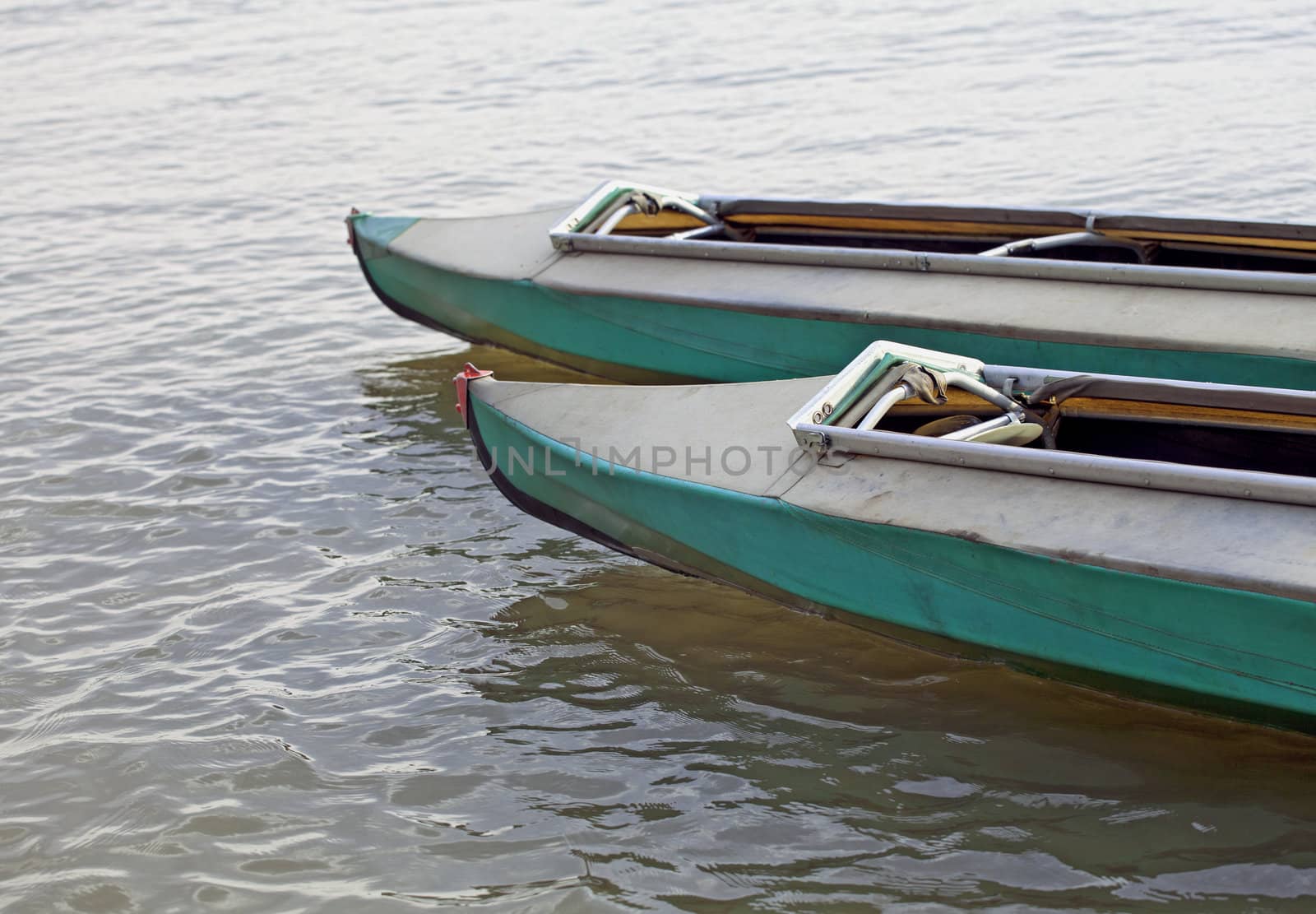 Two canoes on still water of a lake
