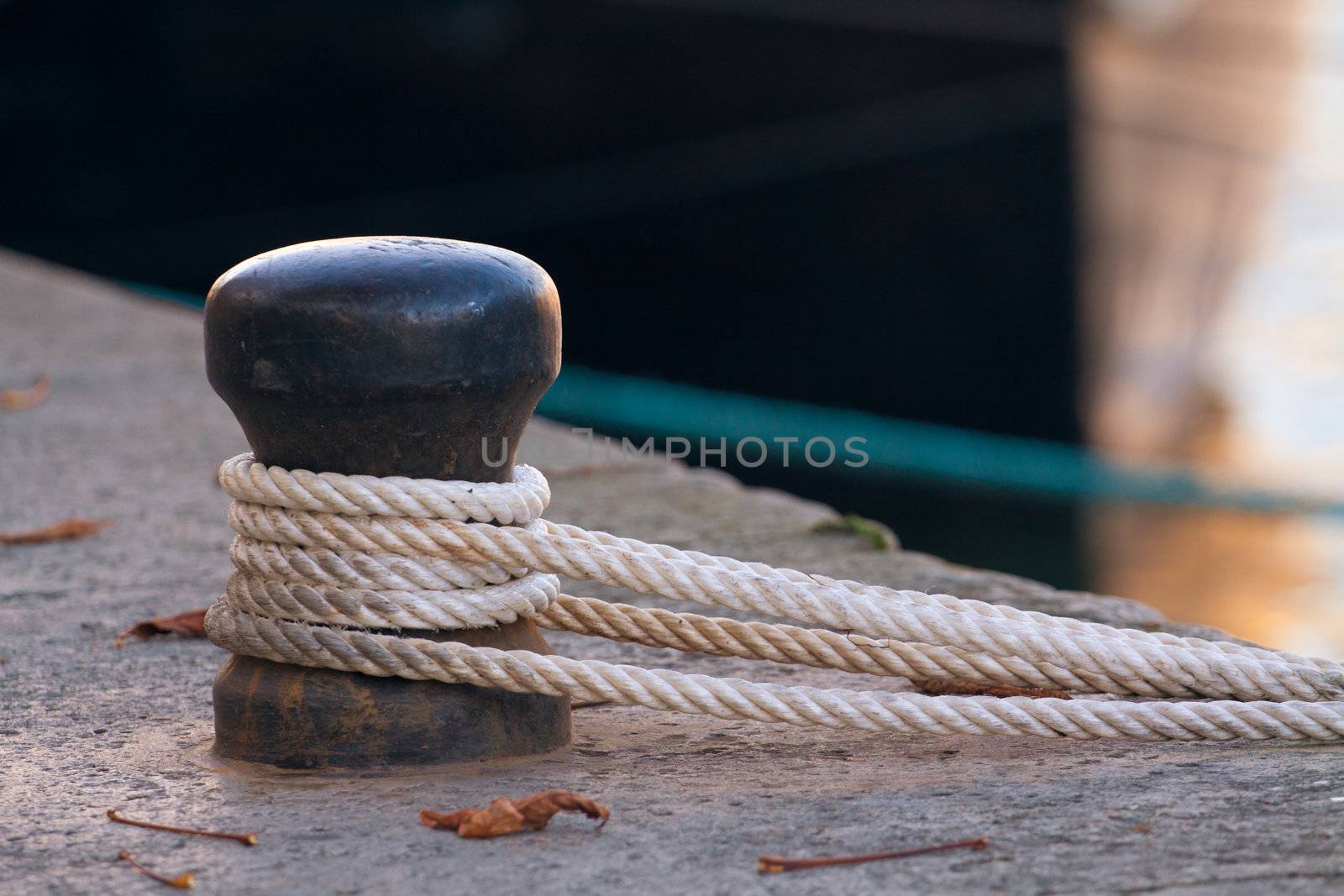 Ship rope tied to a harbor, horizontal shot