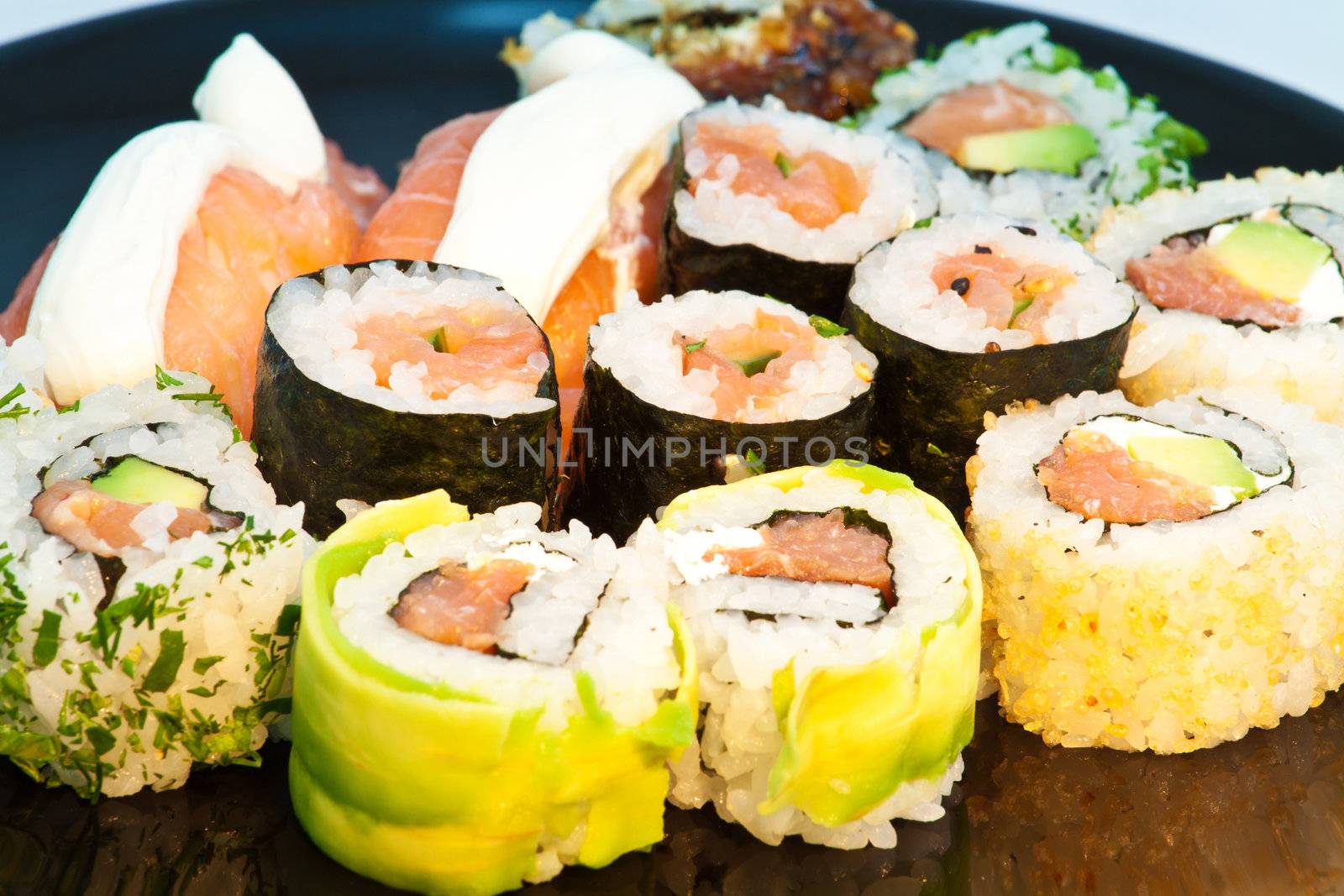 Sushi set in a black plate close up by Lamarinx