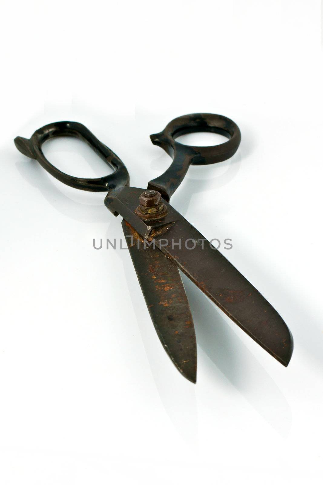 Close up of old rusty scissors isolated on white background